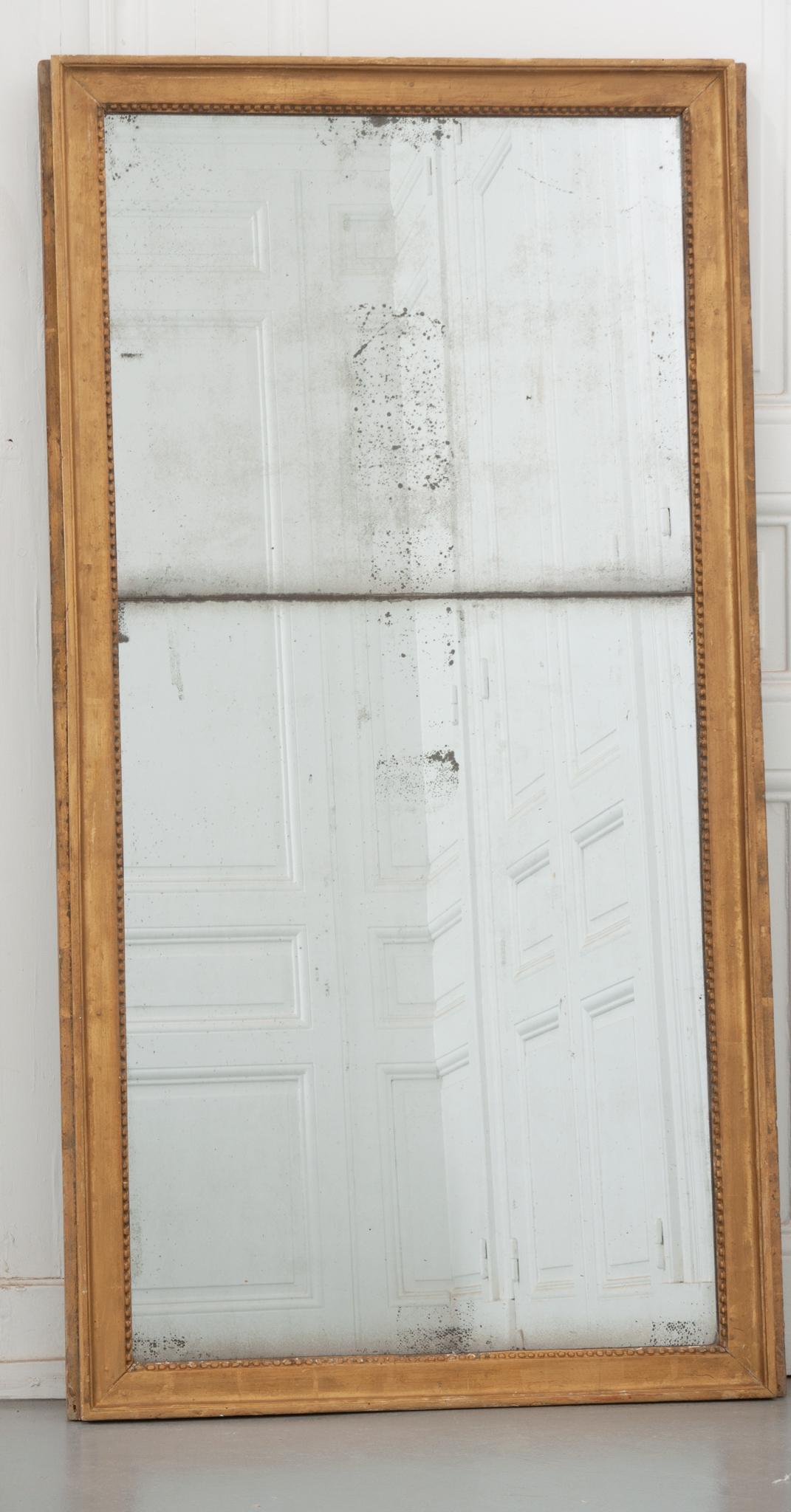 A beautifully simple 19th century mirror with the perfect amount of antique character. The original stacked mirror plates, from a time before large single plates of glass were available in France, have a touch of foxing that gives the whole a great