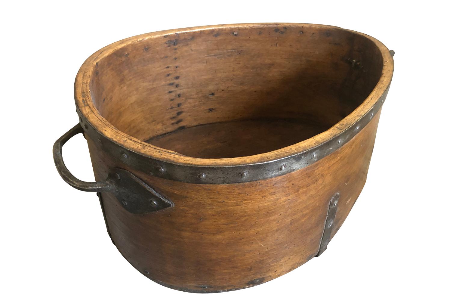 A very charming French 19th century grain measure of unusual form crafted from wood and iron. A terrific decorative vessel or container for a kitchen.