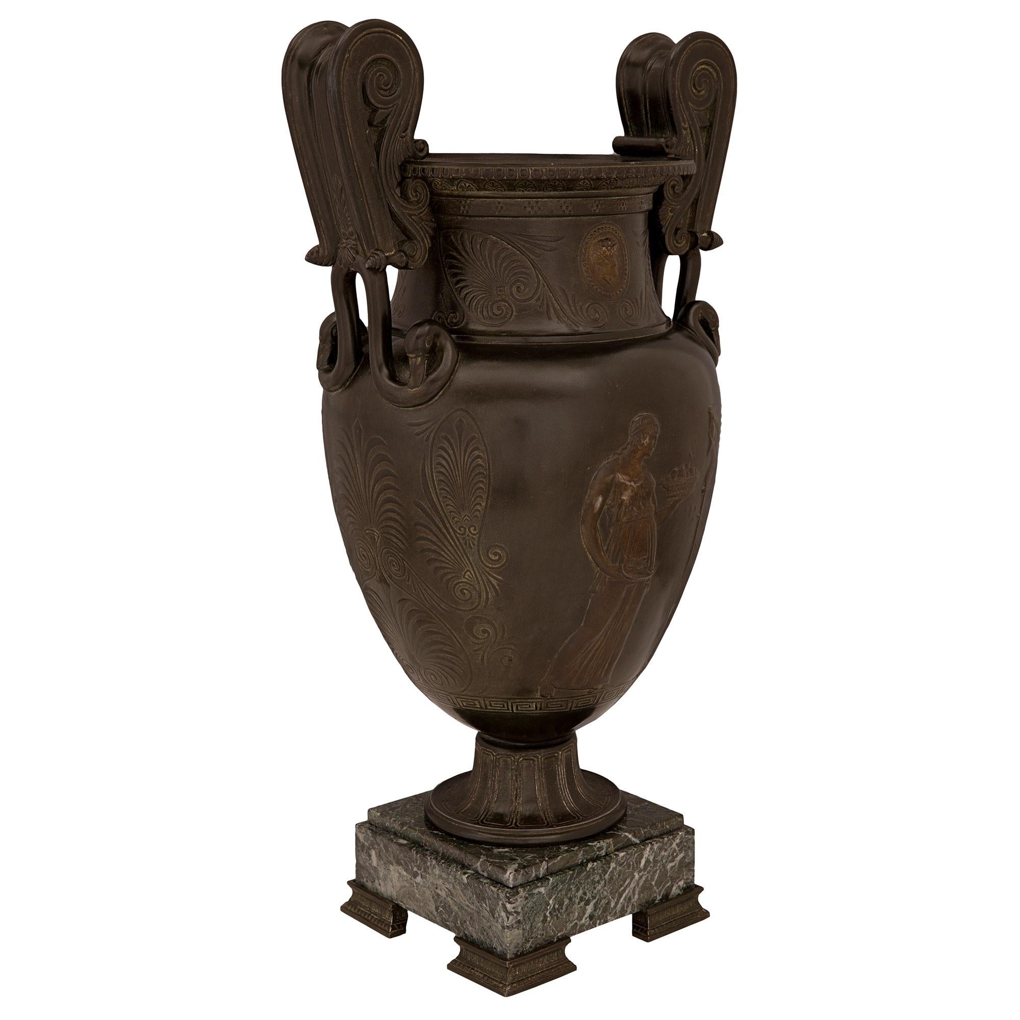 A handsome French 19th century Grand Tour period patinated bronze and Vert de Patricia marble urn. The urn is raised by a square Vert de Patricia marble base with lightly curved fluted patinated bronze feet and a fine mottled border. The urn above