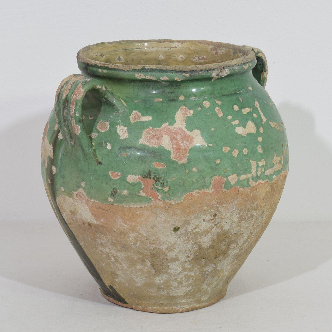 Beautiful weathered confit jar. With green glaze they are extremely rare. Confit jars were used primarily in the South of France for the preservation of meats such as duck or goose for dishes such as cassoulet or foie gras. The bottom halves were