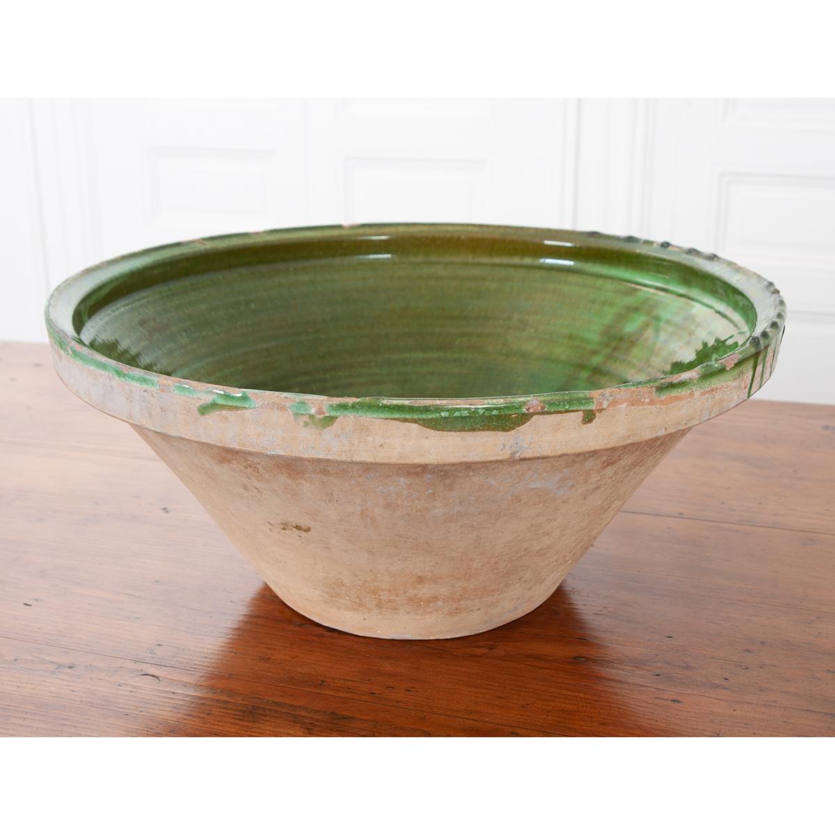 This terracotta mixing bowl has a green glazed interior, made for mixing in the kitchen. It’s a wonderful example of antique kitchenware and can be used in many applications today.