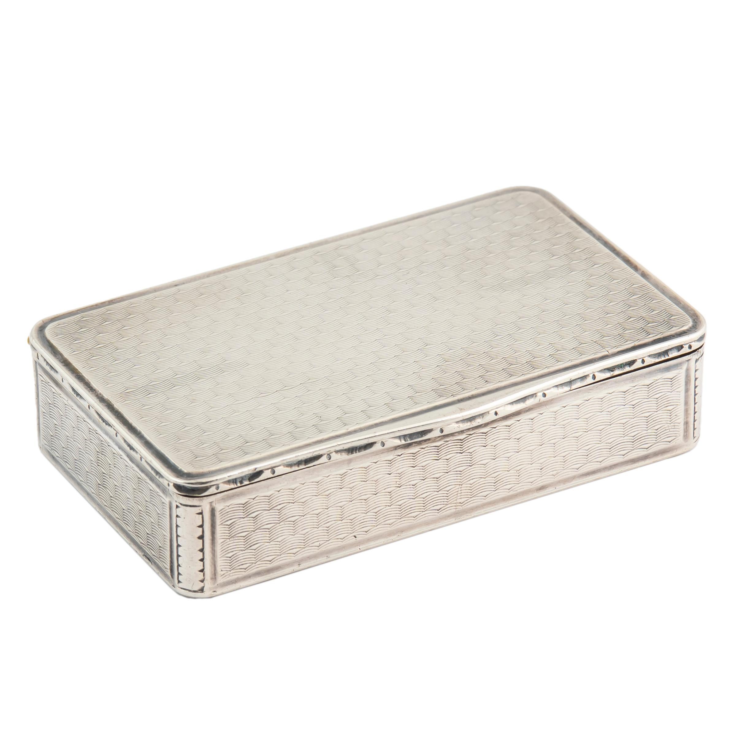 An elegant French silver tabatière or snuff box, overall decorated with guilloché or engine-turned panels, in a regular wavy pattern creating the illusion of movement. In fine condition with original gilded or vermeil interior. The French invented
