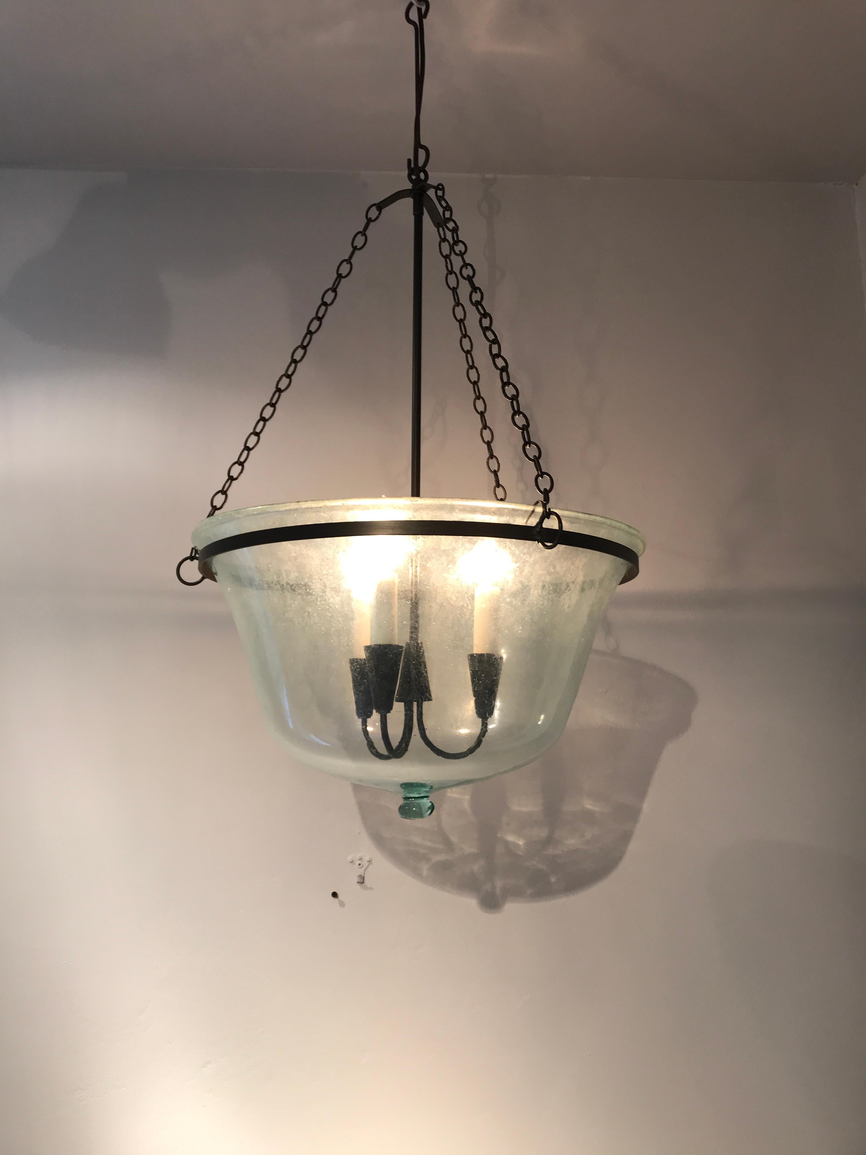 We have always had a thing for hand blown French garden cloches that come in two configurations: Bell form and melon form. This one is a melon cloche (a little shorter and wider than a bell cloche) and it has been converted into a hanging light with
