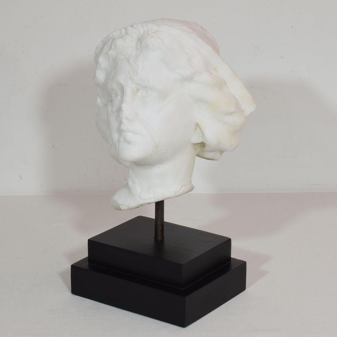 Wonderful marble head fragment. Beautiful weathered expression due to erosion because it always stood outside. France circa 1850-1900 Weathered.
Measurement includes the wooden base.
 