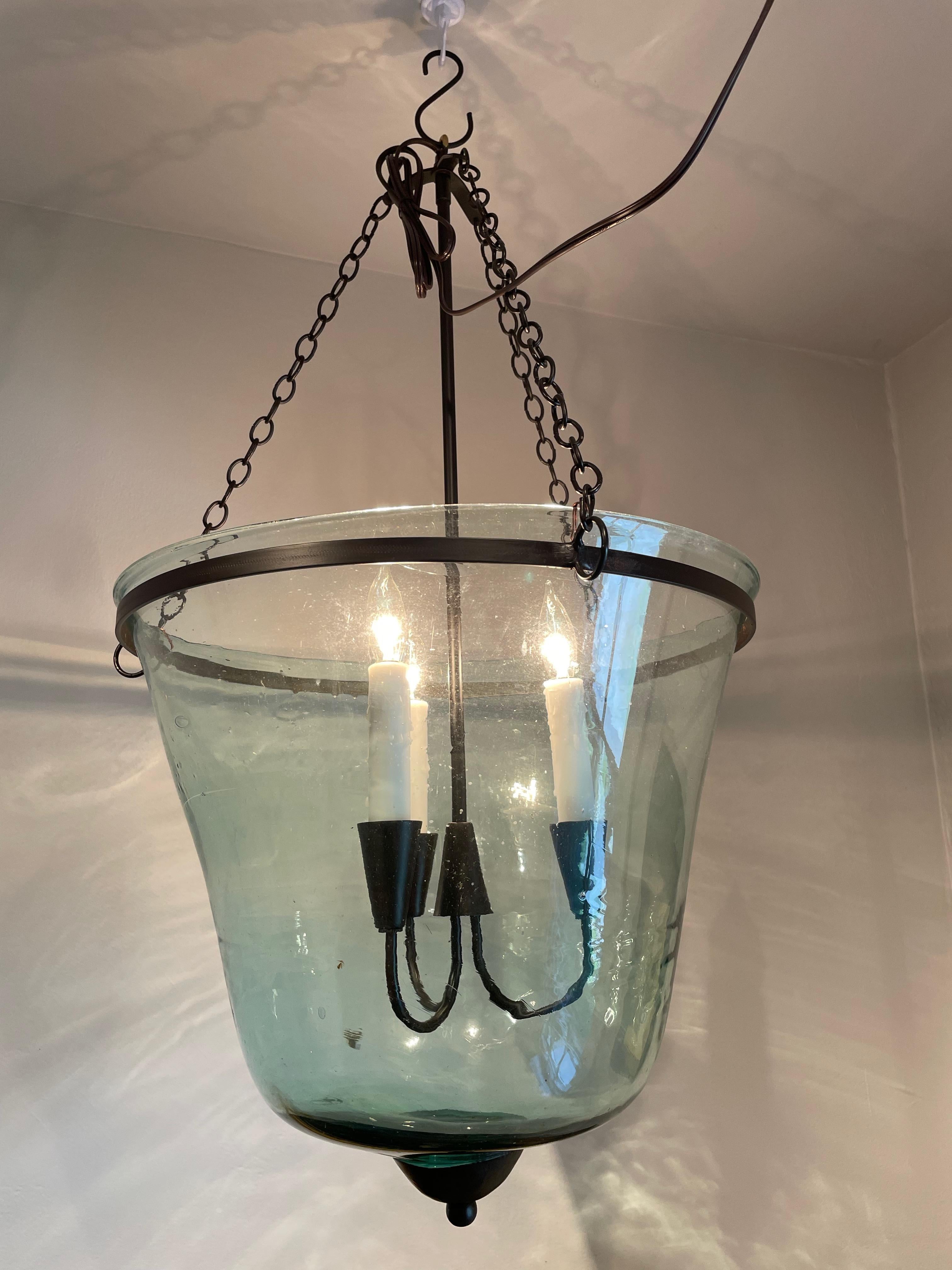 We have always had a thing for hand-blown French garden cloches that come in two configurations: bell form and melon form. This one is a bell cloche (a little taller and more narrow than a melon cloche) and it has been converted into a hanging light