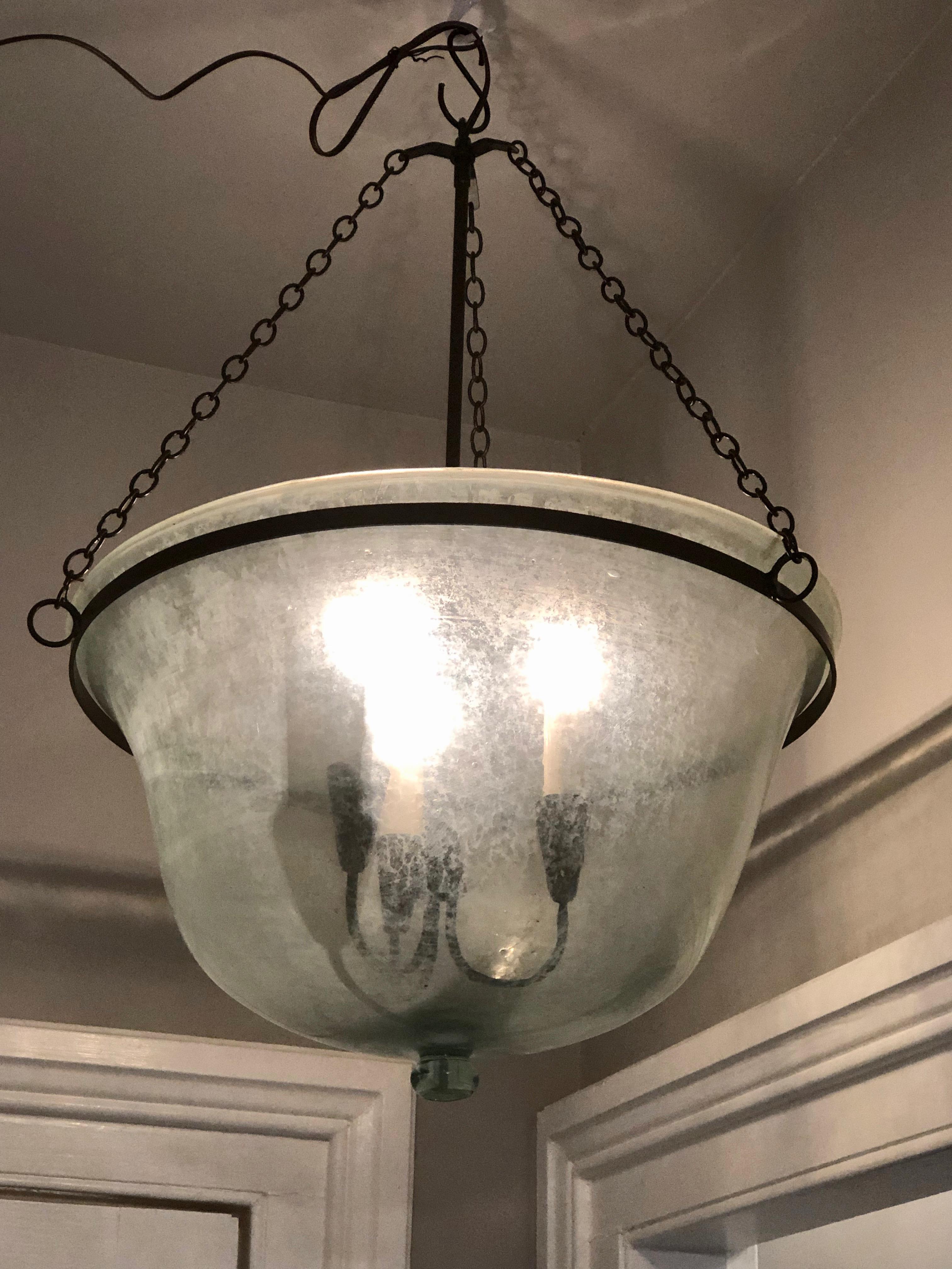 We have always had a thing for hand blown French garden cloches that come in two configurations, bell form and melon form. This one is a melon cloche (a little shorter and wider than a bell cloche) and it has been converted into a hanging light with