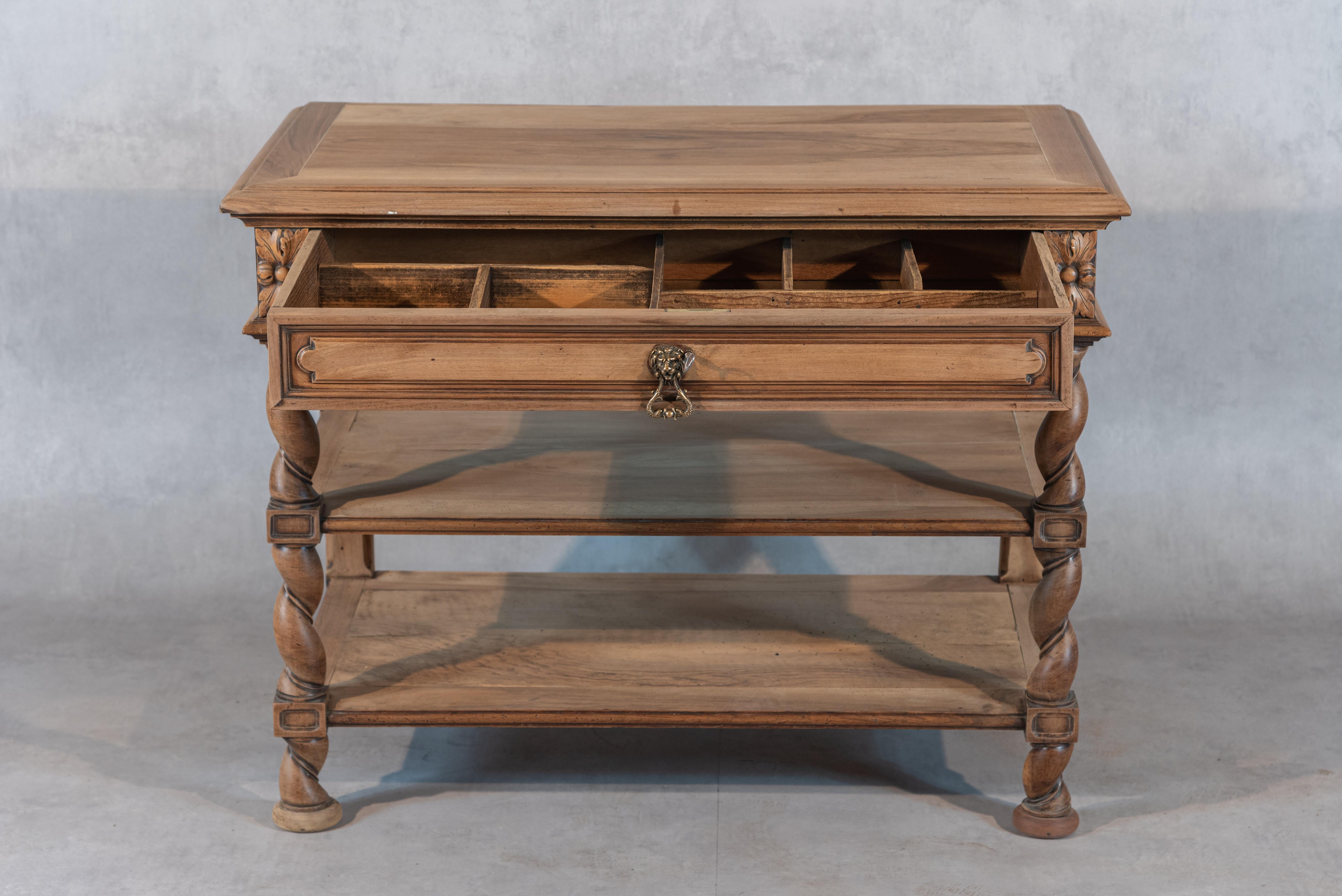 This French 19th century Henri II bleached Desserte is made of walnut and features impressive curled columns on the sides. With a drawer and two shelves, this desserte offers both practicality and a unique style that will truly add charm and