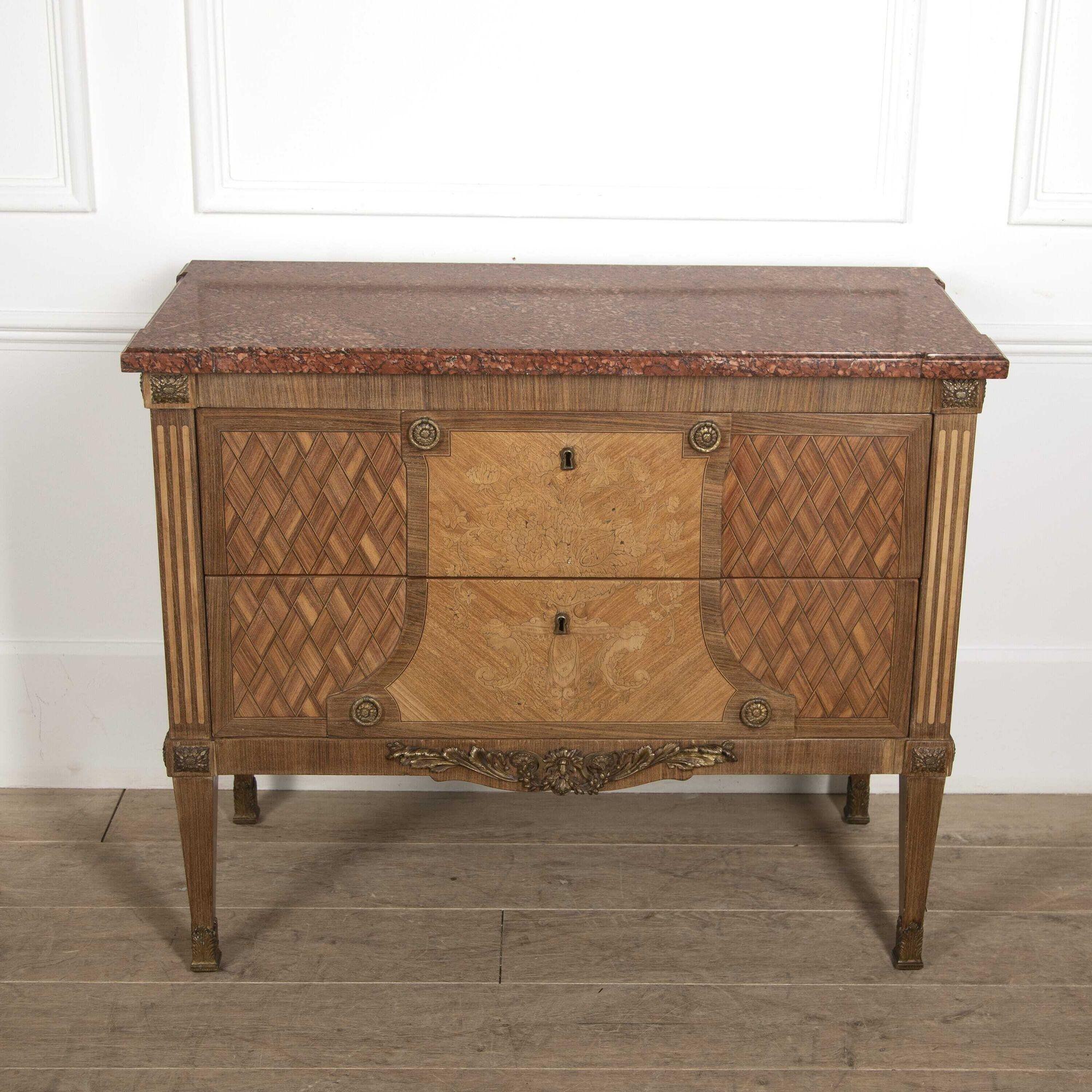 French 19th century Marquetry two-drawer commode with a wonderful marble top.
Featuring wonderful inlaid decoration, this commode conveys typical Empire styles. 
A great storage piece to add to a bedroom or dressing room setting.
