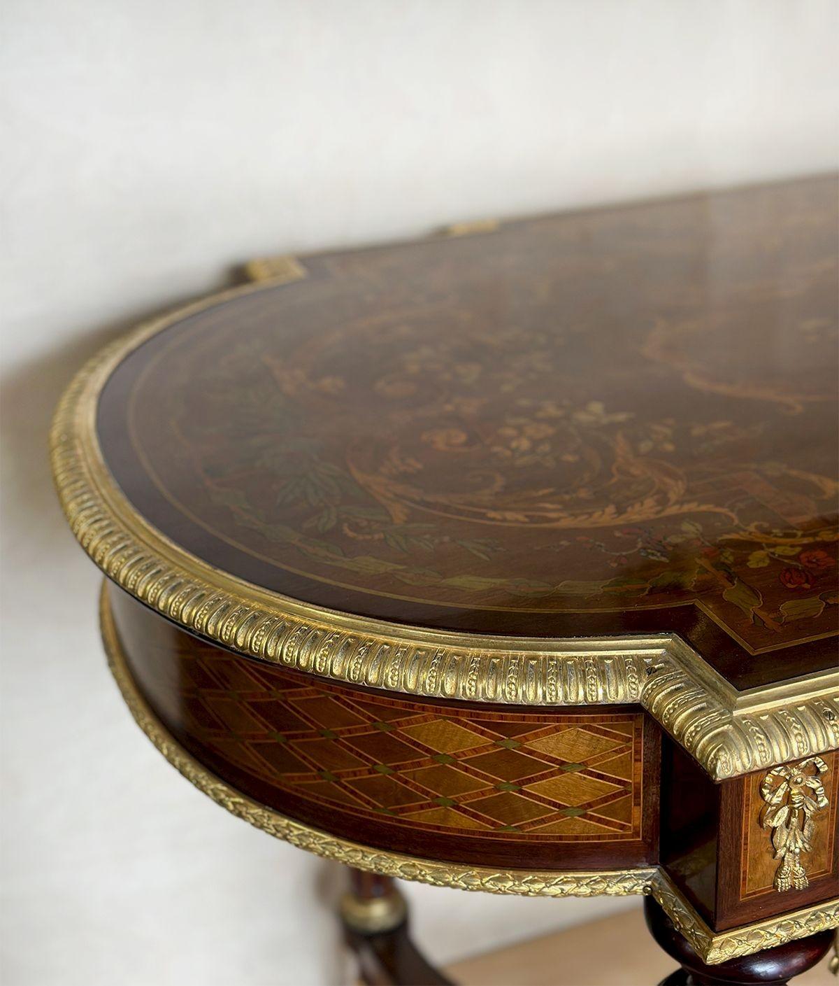 Table d'appoint traditionnelle de style Napoléon III présentant une marqueterie de bois colorée et des incrustations de parquet, composées de motifs botaniques, de motifs floraux et de différents motifs.
Il s'ouvre par un grand tiroir frontal qui