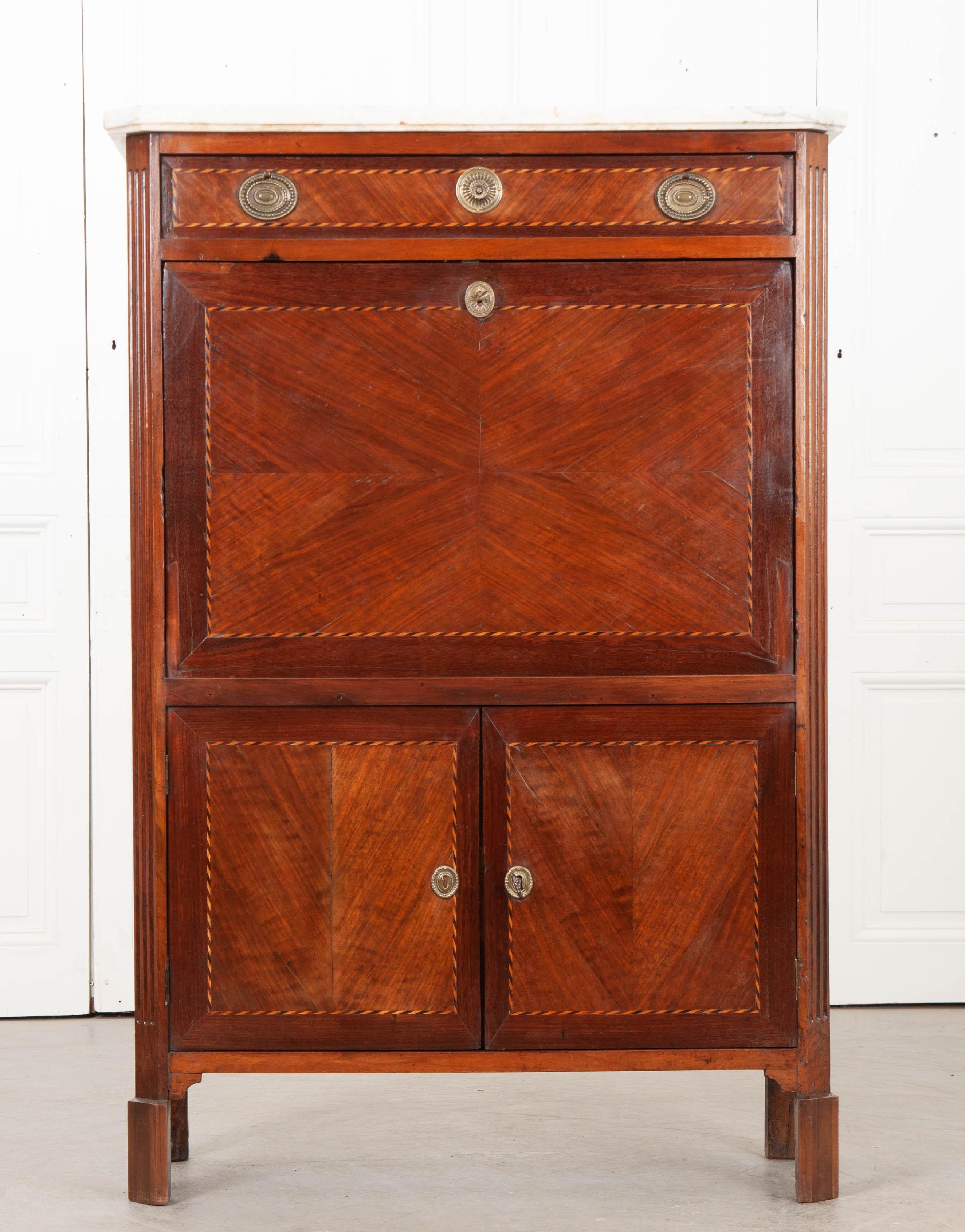 Inlaid details grace many of this 19th century French secretary’s surfaces. Both the exterior doors and drawers are trimmed in satinwood and mahogany, done in a twist-motif. The interior drawer fronts have satinwood inlay, laid into the wood in