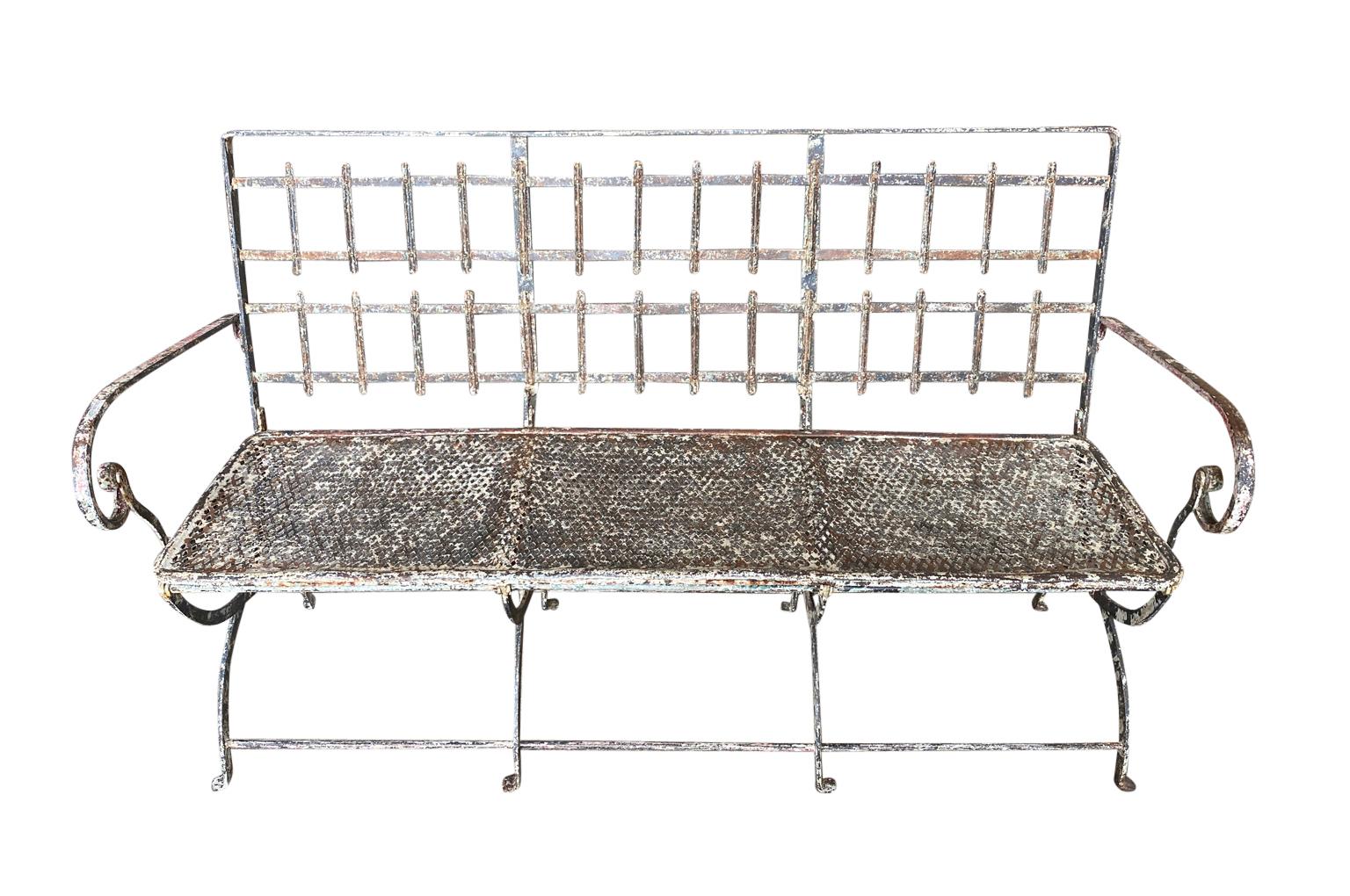 A very charming 19th century Garden Bench from the Provence region of France. Soundly constructed from painted iron. The bench is collapsible. The seat height is 16 1/4