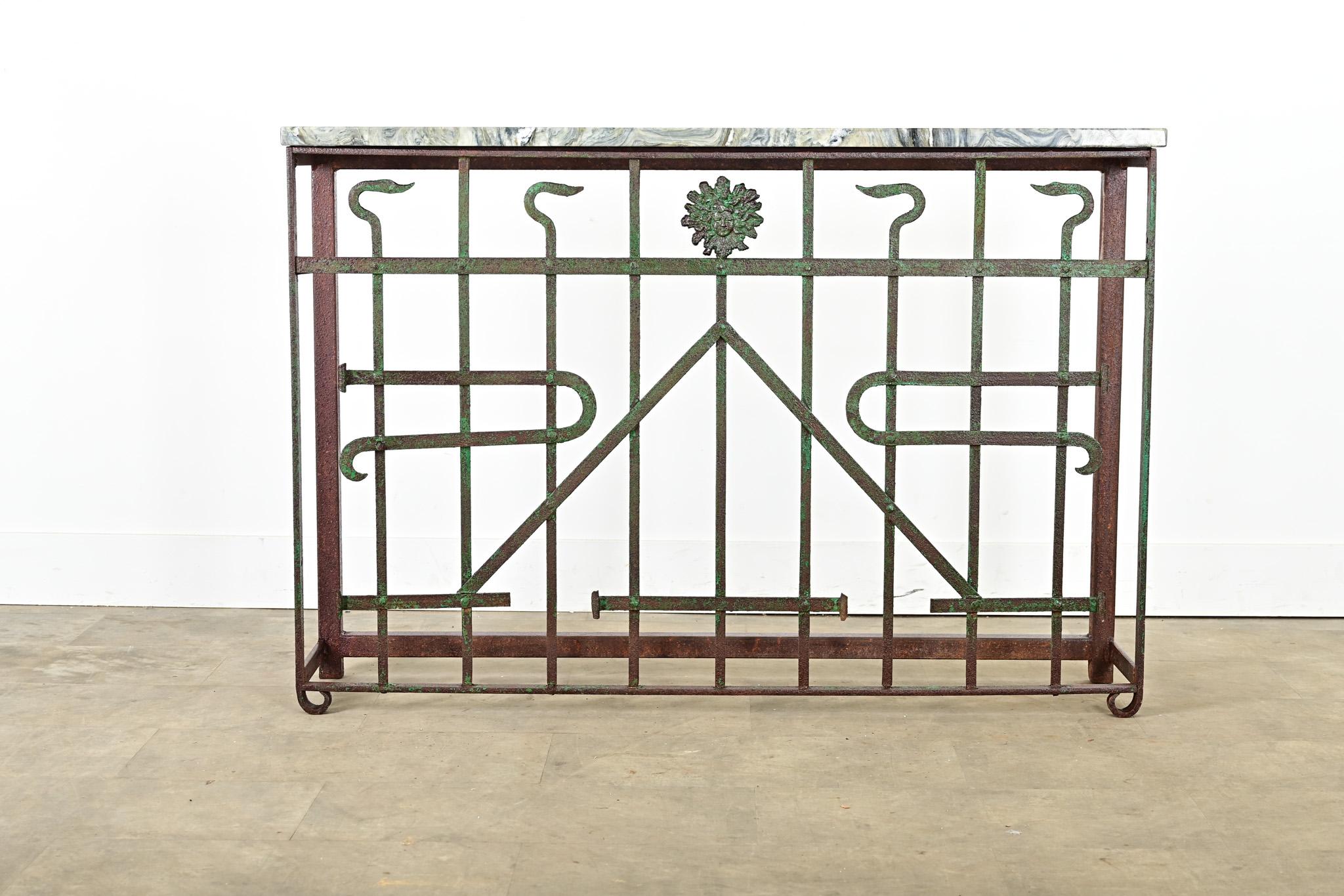 French 19th century cast iron balcony railing, repurposed as a stunning console table. On top is a narrow slab of (new) blue-green stone animated by painterly veining in dense accumulations of fine ripples, surrounding a few patches of white. The
