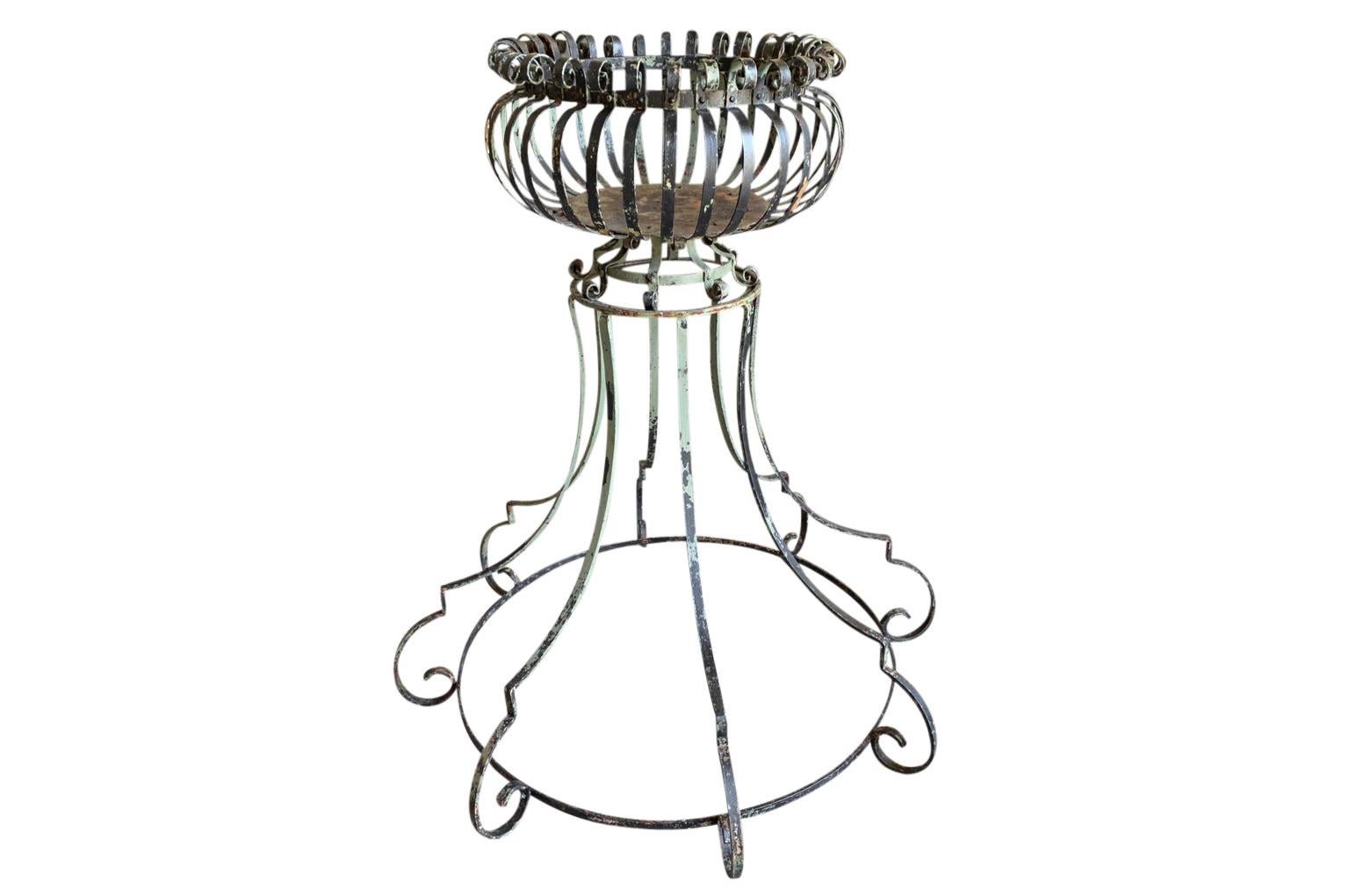 A charming later 19th century Jardiniere - Porte Plante from the South of France.  Beautifully constructed from painted iron.  A wonderful accent piece for any interior or garden.  The diameter of the top is 24 1/4