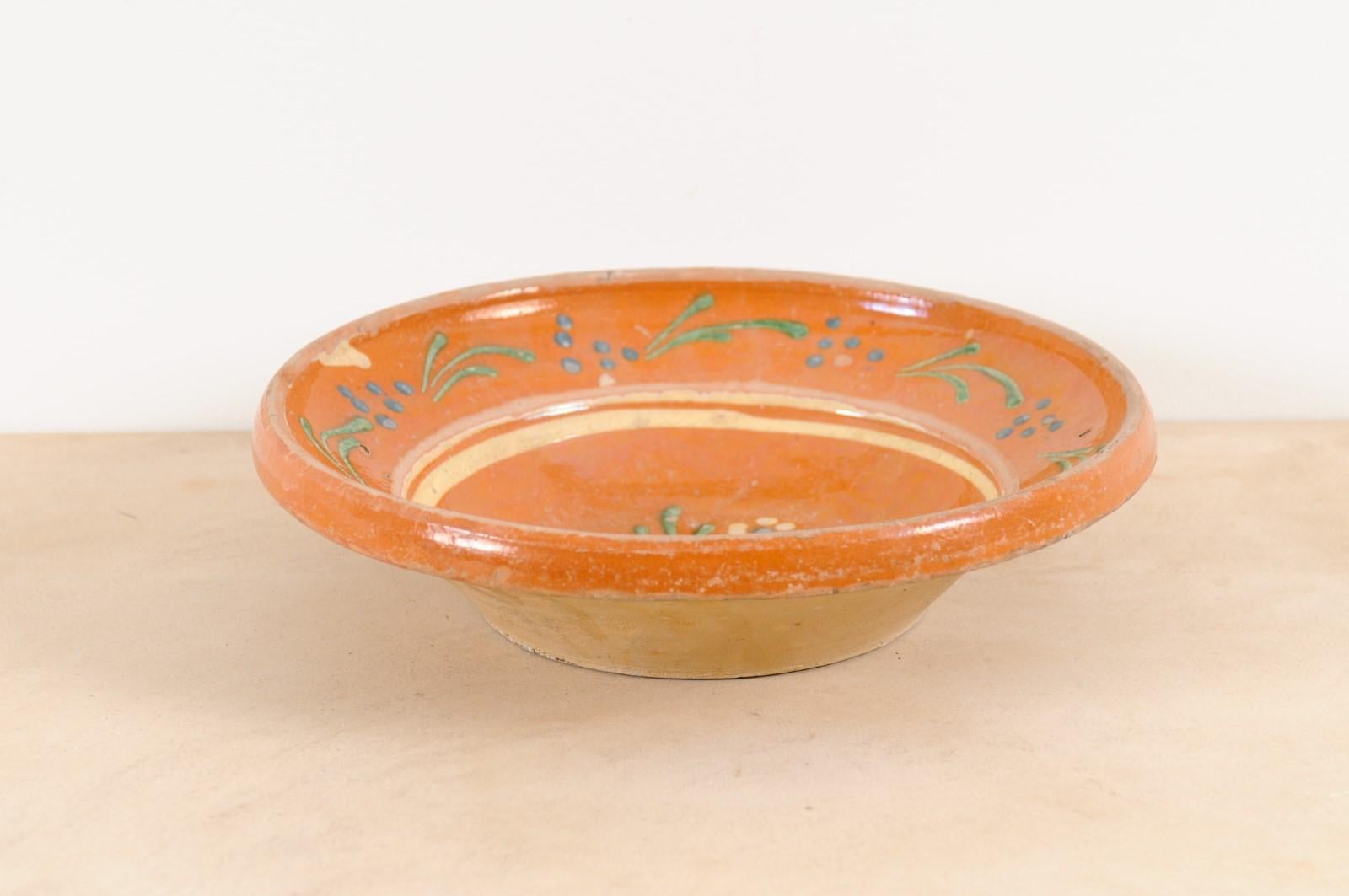 A French jaspe pottery bowl from the 19th century, with russet ground and floral motifs. Charming us with its earthy ground adorned with blue and green floral accents, this French 19th century jaspe pottery bowl will bring an unpretentious presence