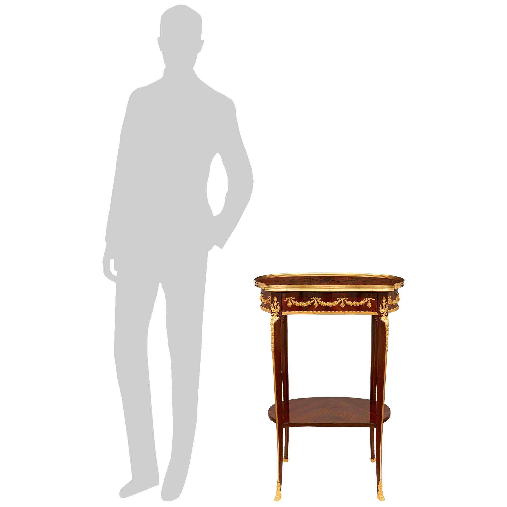 Superbe table d'appoint en bois de roi, palissandre et bronze doré, de grande qualité, datant de la période Belle Epoque du 19e siècle. en bois de roi, palissandre et bronze doré, à la manière de Linke. Cette très belle table en forme de rein repose