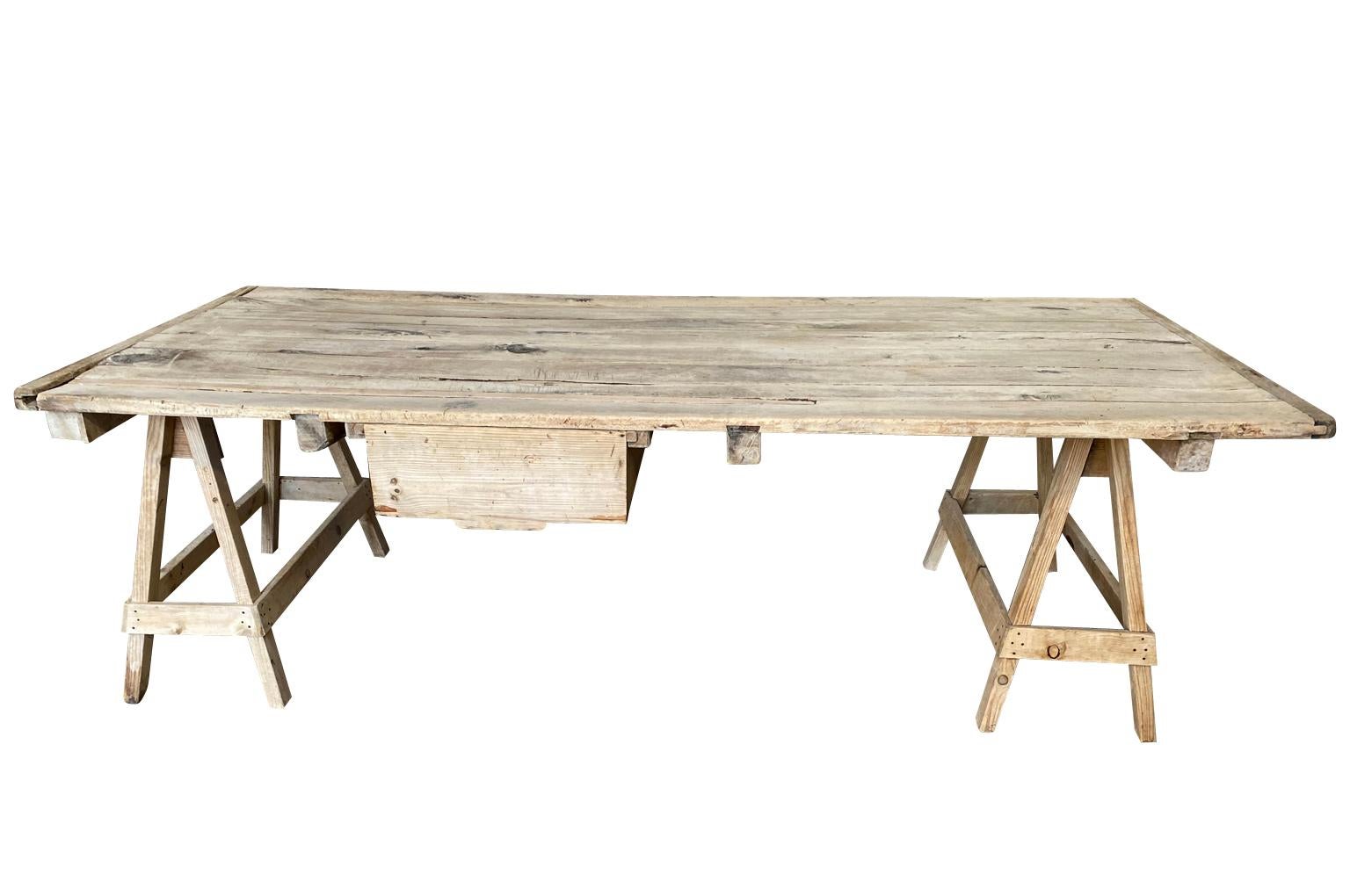A very beautiful late 19th century table De Coutelier - knife maker's table from the Provence region of France. Handsomely constructed from pine and beechwood on saw horse legs and a large drawer for knife storage. A terrific table that will serve