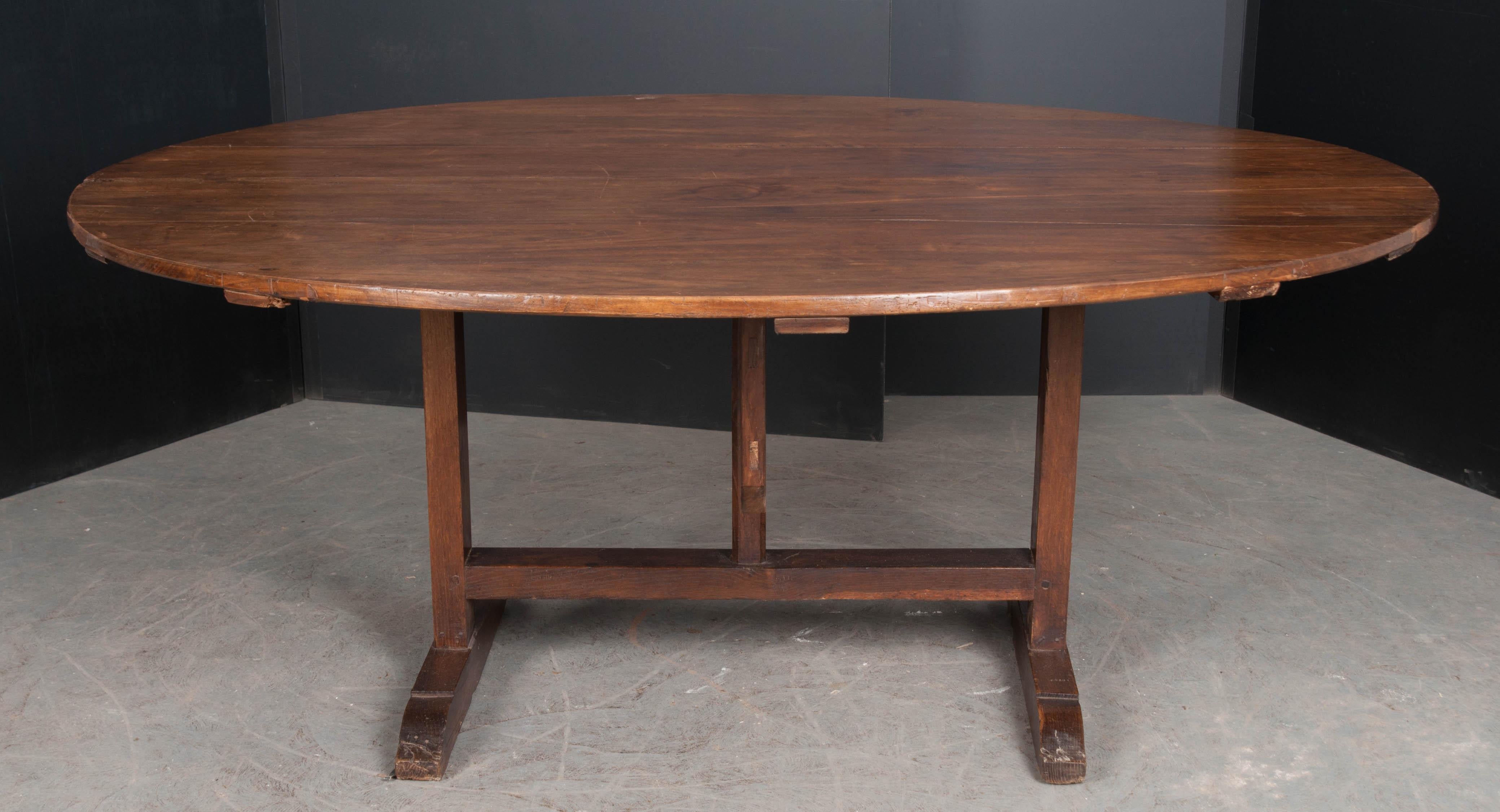 This walnut wine tasting table was made in France, circa 1880. These tilting tables are fun antiques for both the wine enthusiast and adversary alike. Thoughtfully designed for narrow-corridor wine cellars, they have the ability to tilt into a