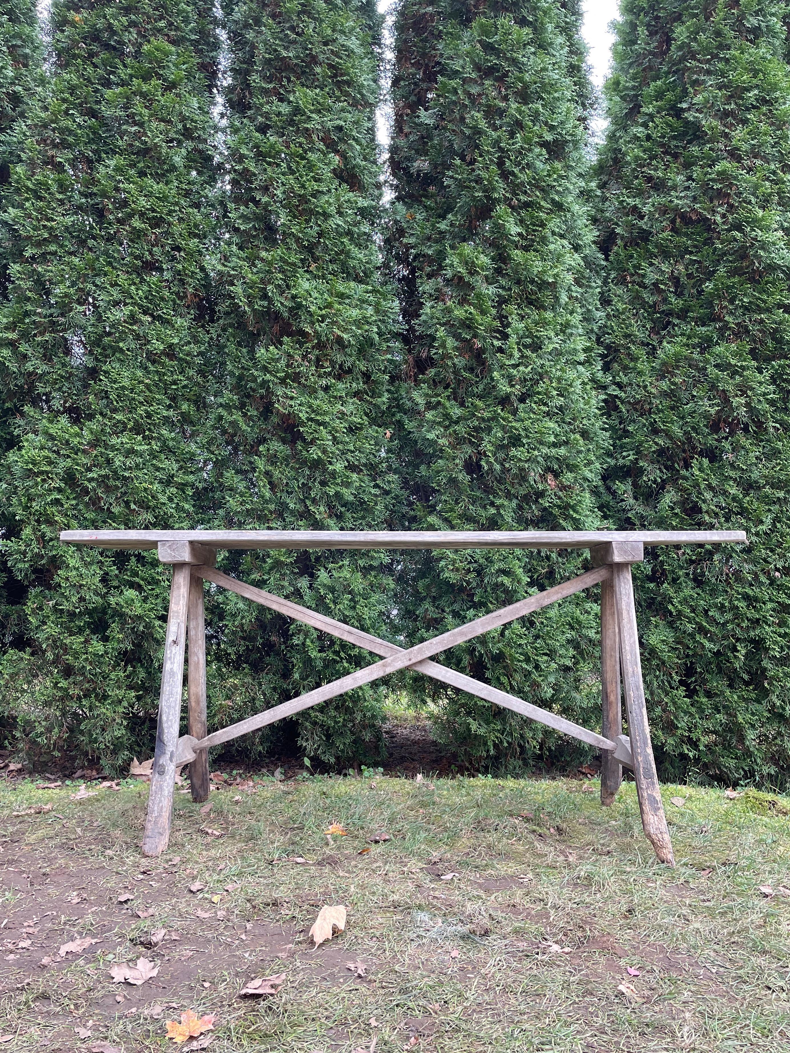 This wonderful late 19th century washing table was used for scrubbing laundry and its rustic hand-made construction is lovely. Made of fir, its single plank top and branch legs have an old world patina that works wonderfully with any decor. Its