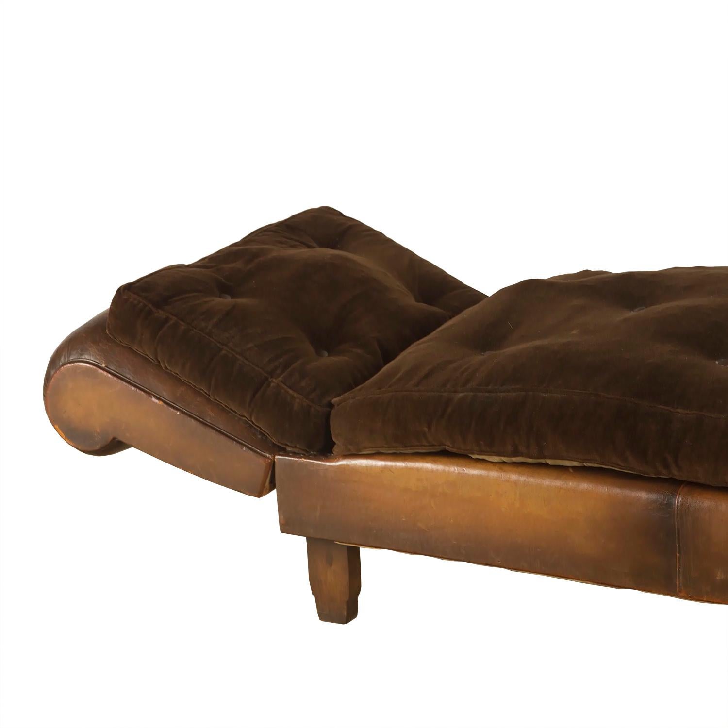 A French leather daybed that also makes a useful sofa. The sides can be dropped to make a daybed. The cushions are upholstered in rich brown velvet.