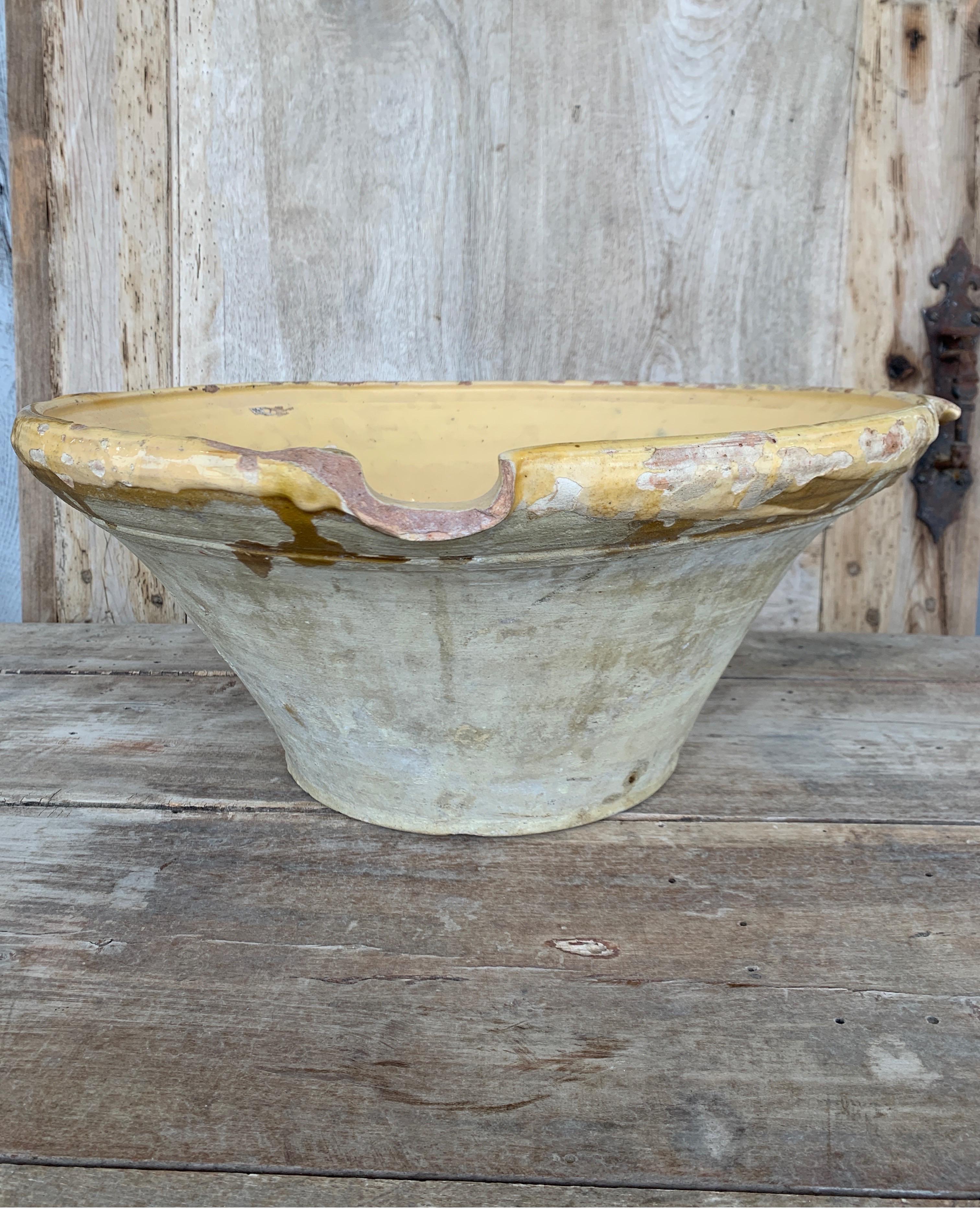 Great size bowl from France with the prettiest lemon color. It does have some small chips on pour spout as well as one handle broken but it adds to the antique character. Measures: 19 3/4 W x 18 5/8 D x 8 T.