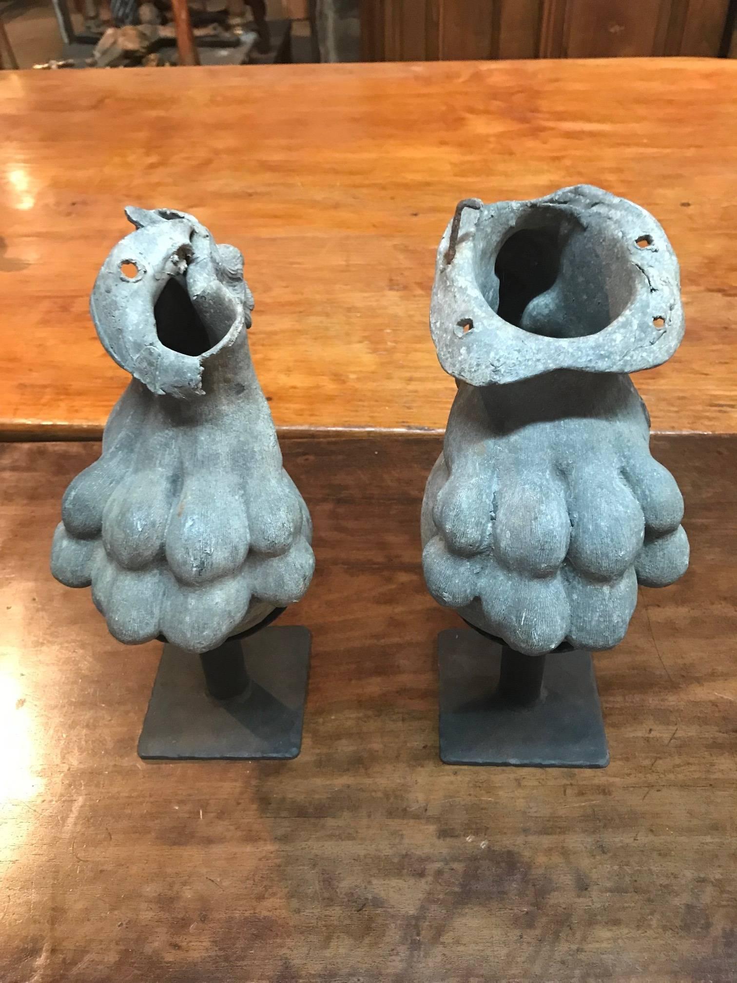 A wonderful pair of French 19th century lion paw architectural fragments in lead - now displayed from iron stands. Great patina. Perfect bookshelf, table top or mantel accessories.