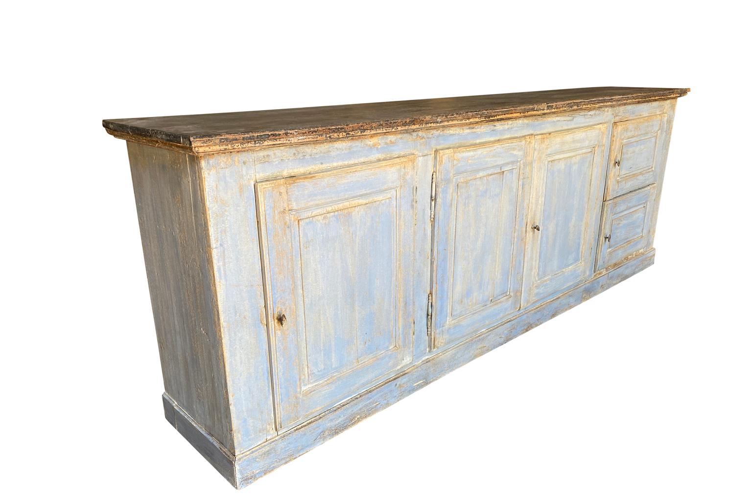 A terrific mid-19th century long enfilade from the Provence region of France. Soundly constructed from painted wood with an interesting configuration of five doors and great patina. Wonderful narrow depth.