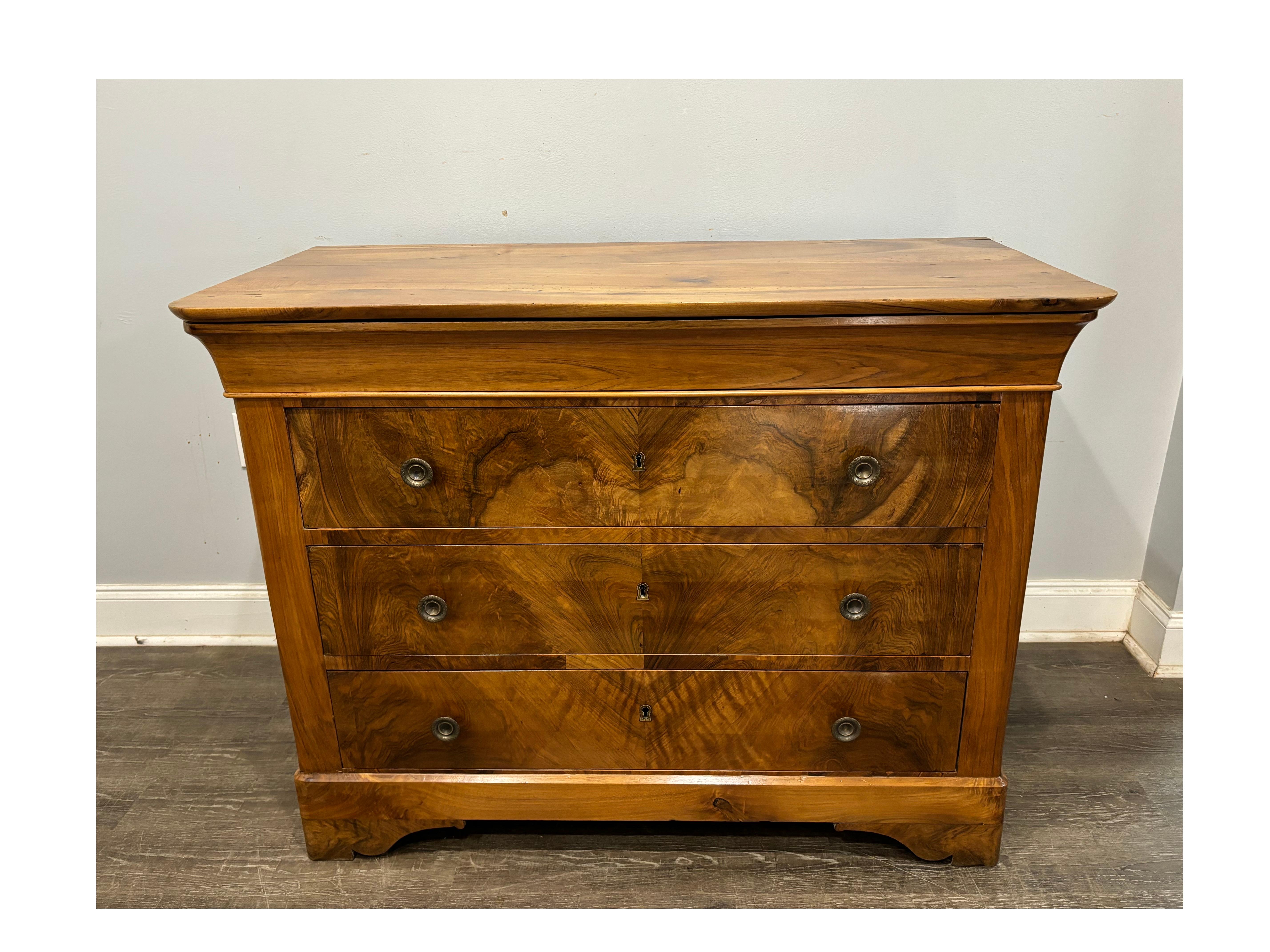 This Commode has a beautiful Blond flamed walnut that shows a heart. The top drawer is nicely curved.