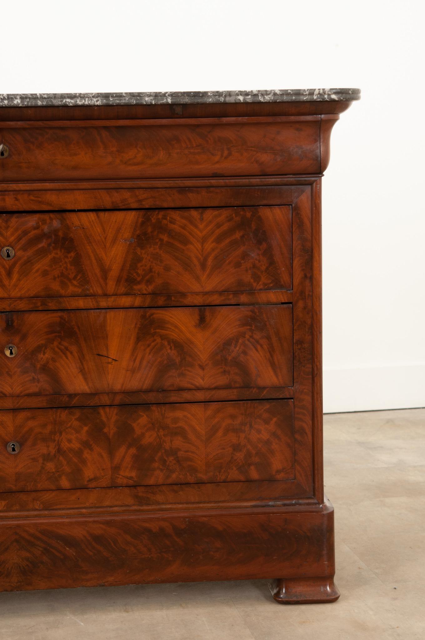 A wonderful 19th century French mahogany Louis Philippe style commode, circa 1830. The original removable marble top in superb antique condition has rounded corners and is shaped to match the base. The marble is gorgeous with dramatic charcoal and