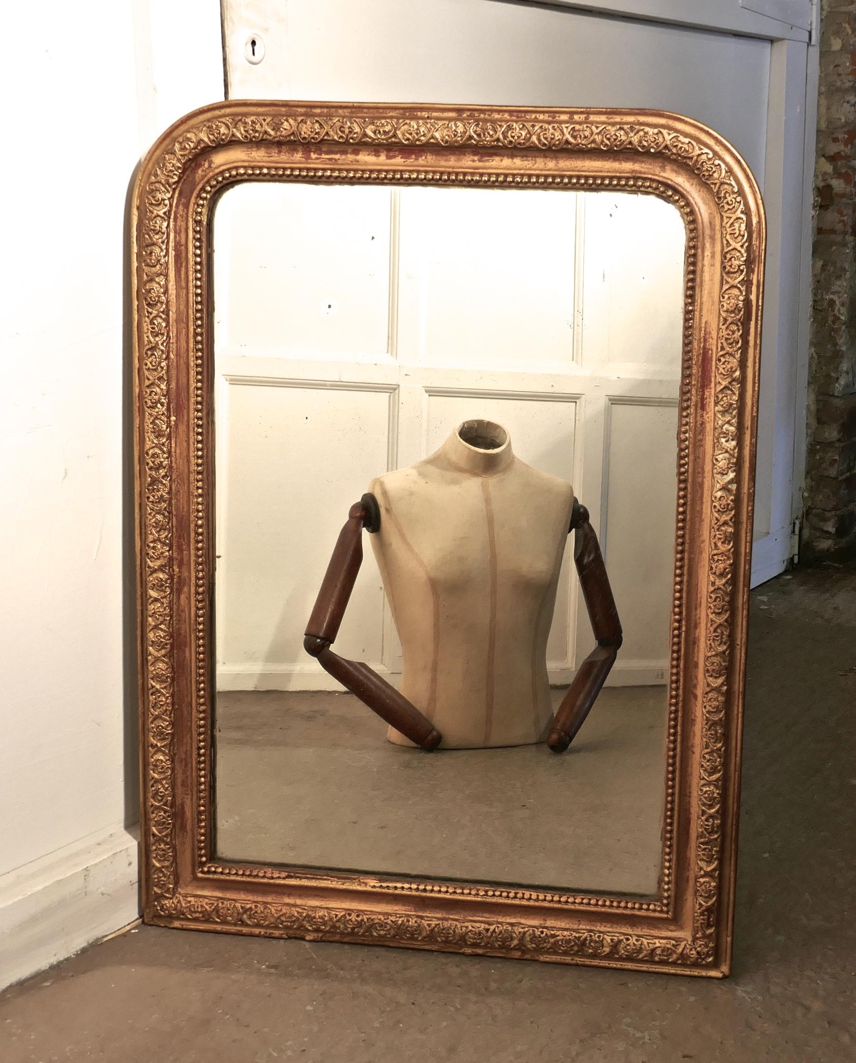 French 19th century Louis Philippe gilt wall mirror. 


This is a charming piece of genuine shabby French chic furnishing, the 3” wide frame has a raised gesso border in gold, some of the red undercoat is showing through, it has age related wear