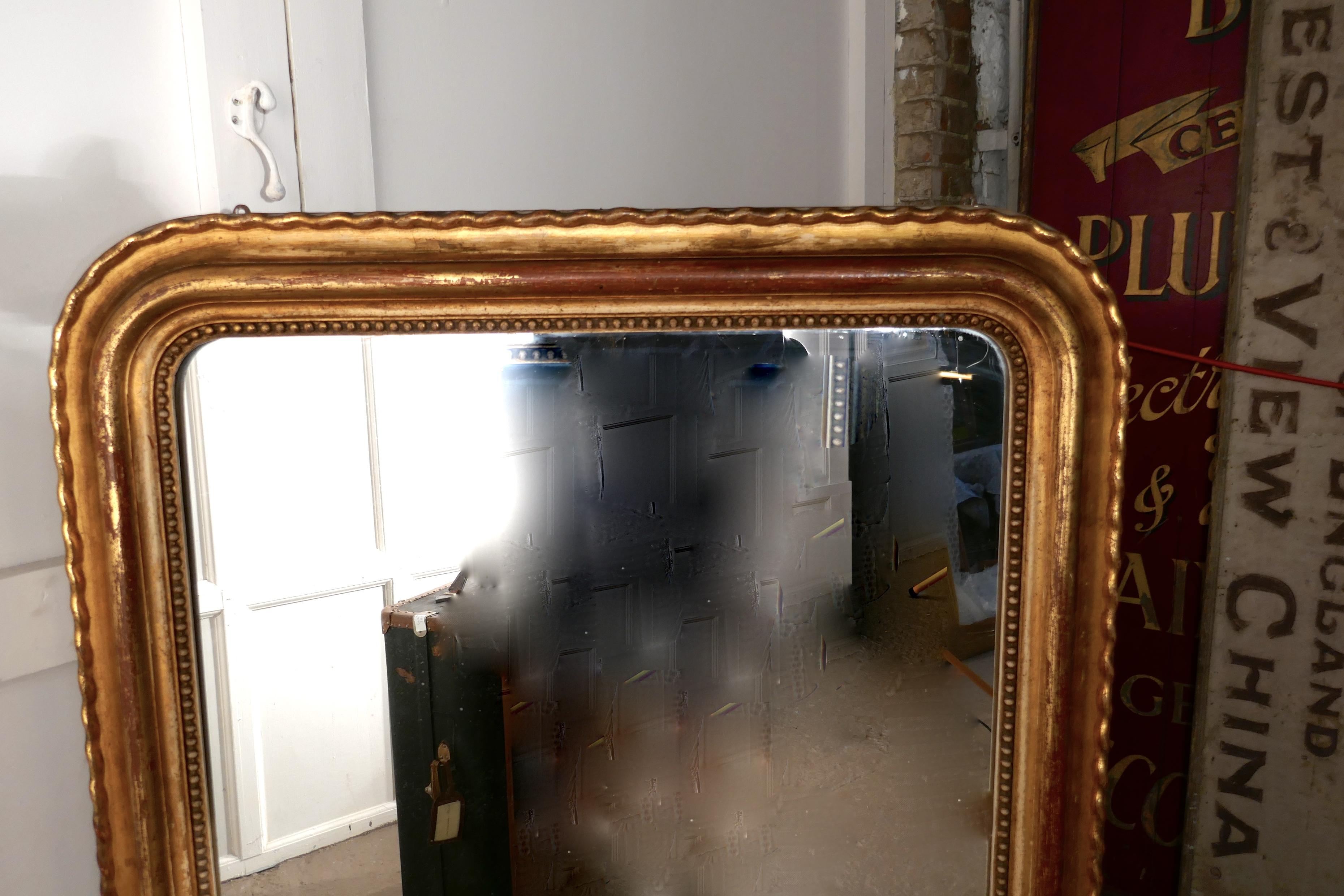 French 19th century Louis Philippe gold mirror

This is a charming wall mirror a genuine example of French chic furnishing, the 5” mirror frame is decorated in gilt with a ribbon design, it has has had a few knocks over the years so it has been