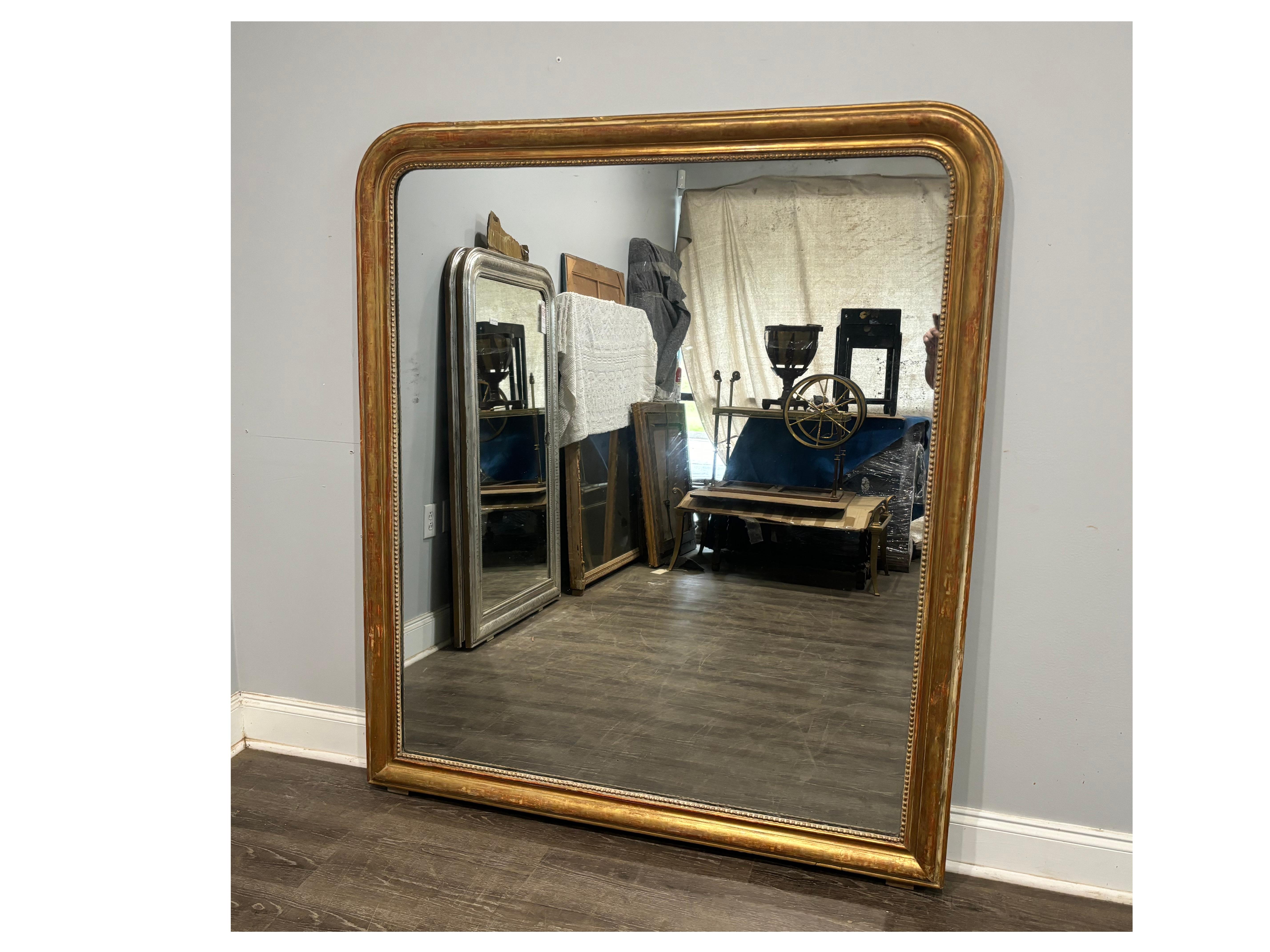 This Louis-Philippe Mirror is covered with gold leaves and wears the use of age. It has a mercury glass.