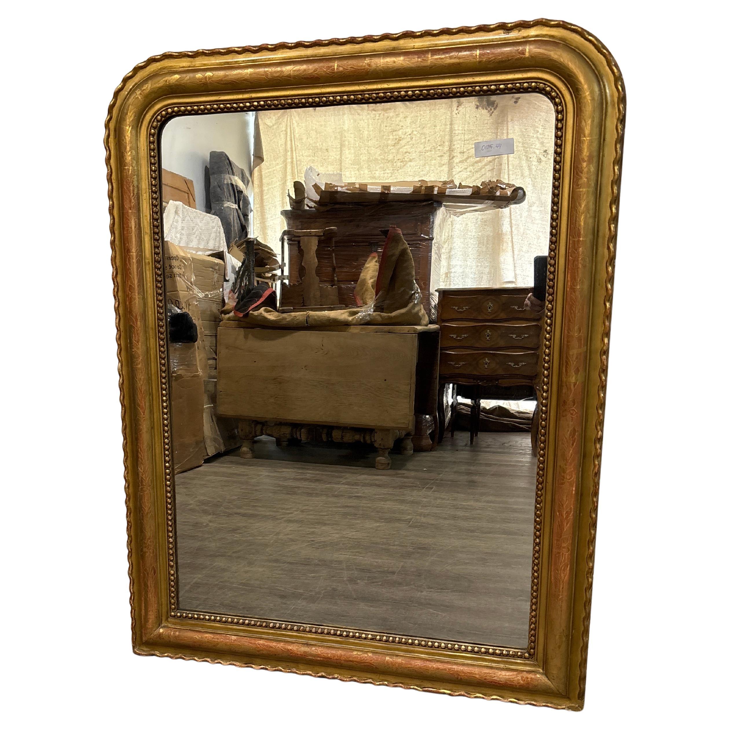 This Louis-Philippe Mirror is covered of golf leaf. It has a mercury glass. 