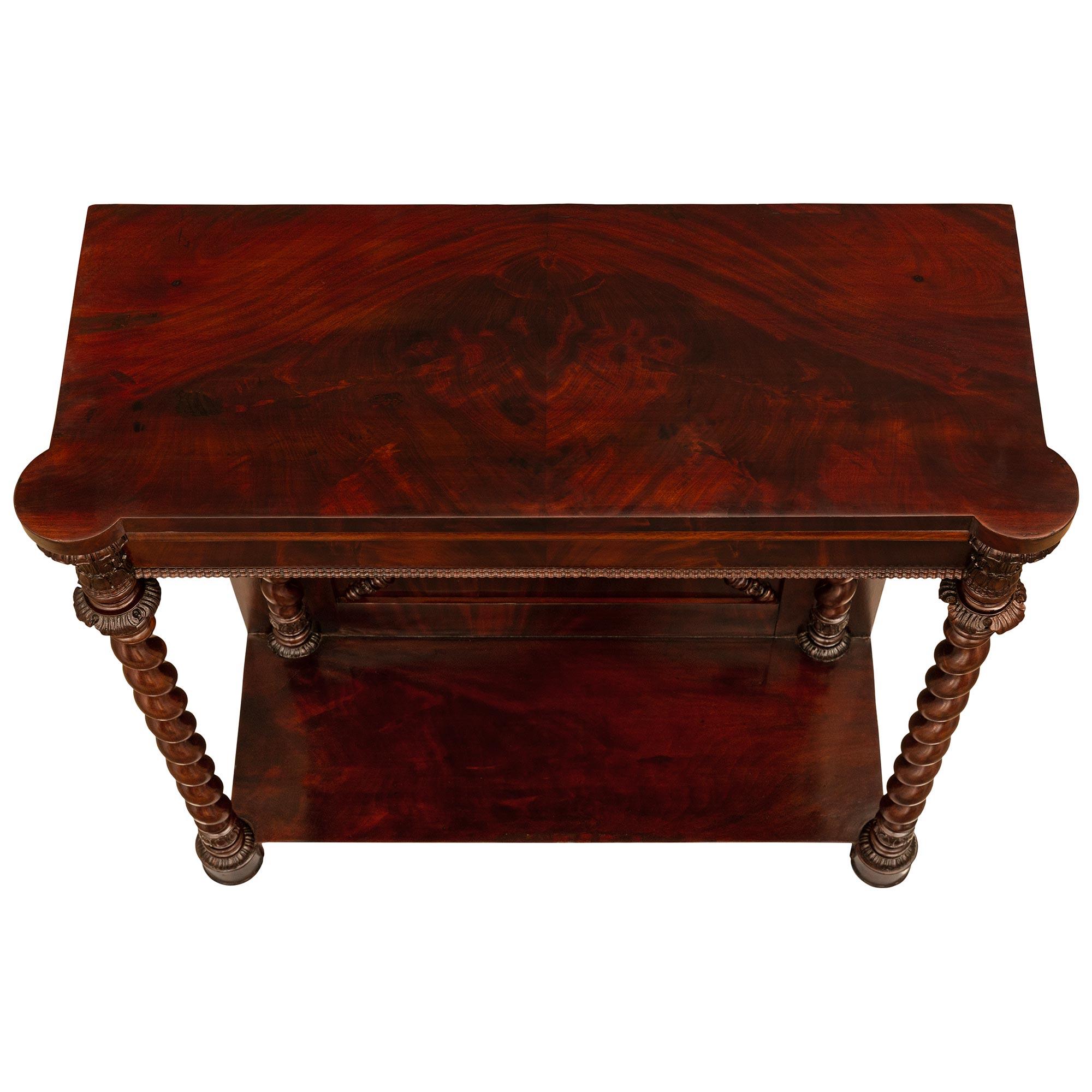 A stunning and high quality French 19th century Louis Philippe Period flamed Mahogany console. The solid Mahogany freestanding console is raised on lovely circular mottled feet joined by a Mahogany display tier below exceptional and most decorative
