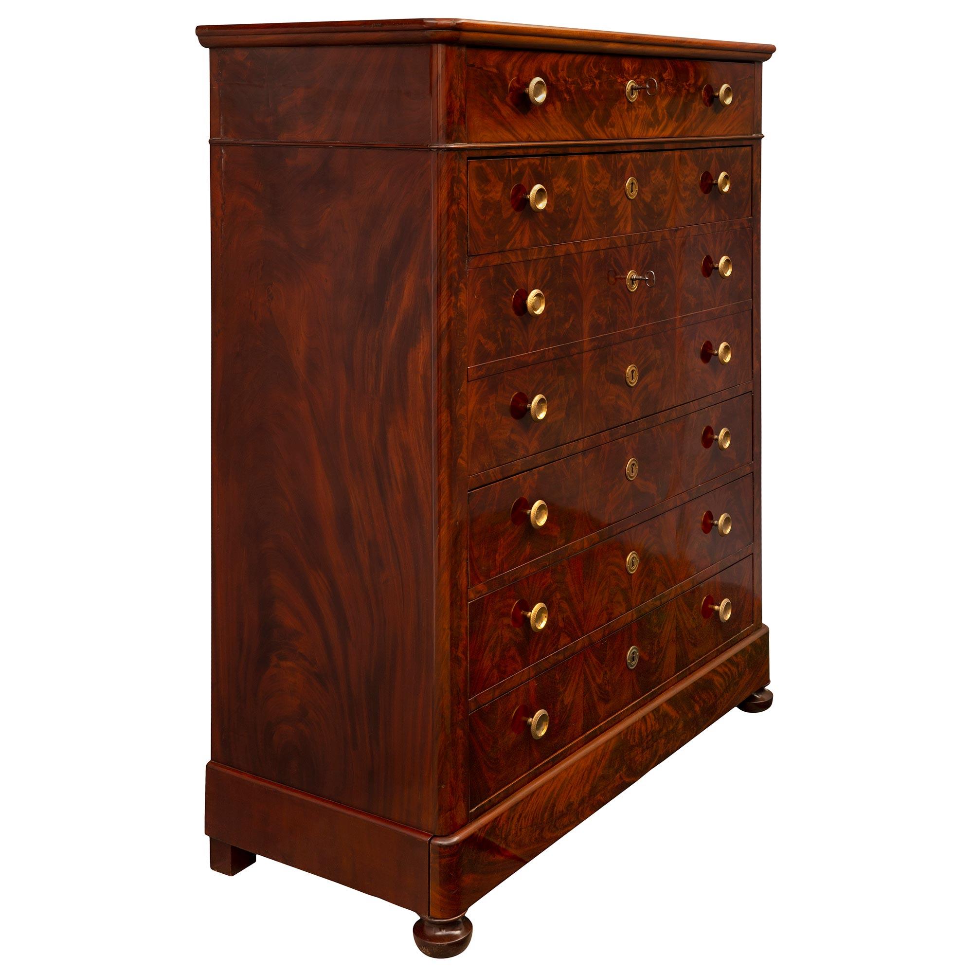 An impressive French mid-19th century Louis Philippe period flamed Mahogany and ormolu secretary circa 1840. The ten drawer secretary is raised by elegant topie shaped feet below the straight frieze which displays one concealed drawer. At the front