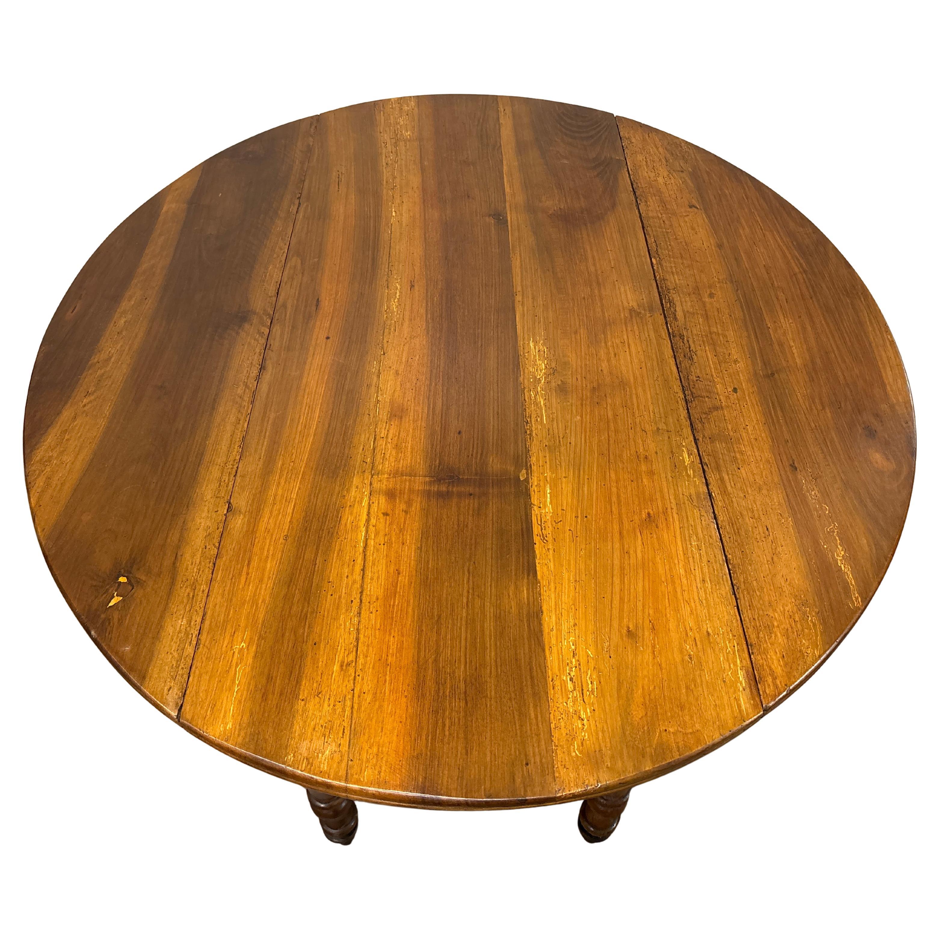 This beautiful drop leaves table is made of flamed walnut. It has 1 drawer and when the leaves are down the dimensions are 20.25”D x 45.5”W.