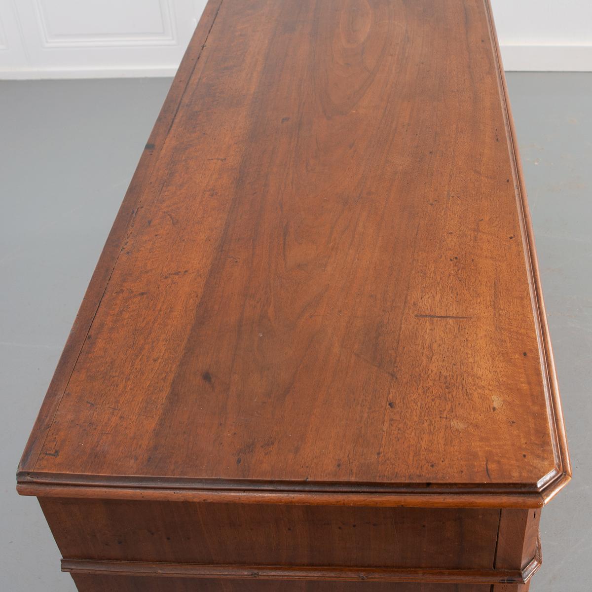 A fabulous Louis Philippe enfilade with three drawers that are set above three doors. This piece comes from 19th century France and is in spectacular condition. A stunning walnut top sits above an apron with three raised panel drawers with their