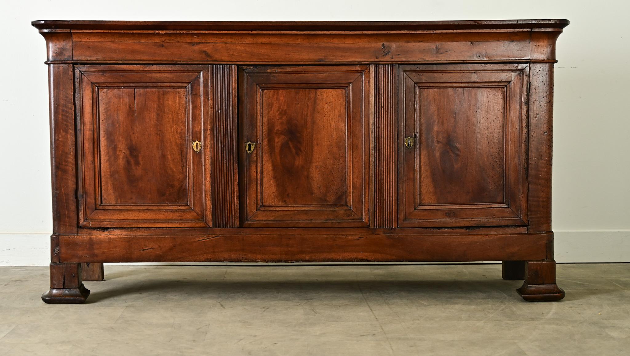 A classic 19th century French solid walnut Louis Philippe enfilade with the substantial presence to anchor any space. The expertise of the artisan is evident as beautiful construction that highlights the grain patterns; now two centuries of patina