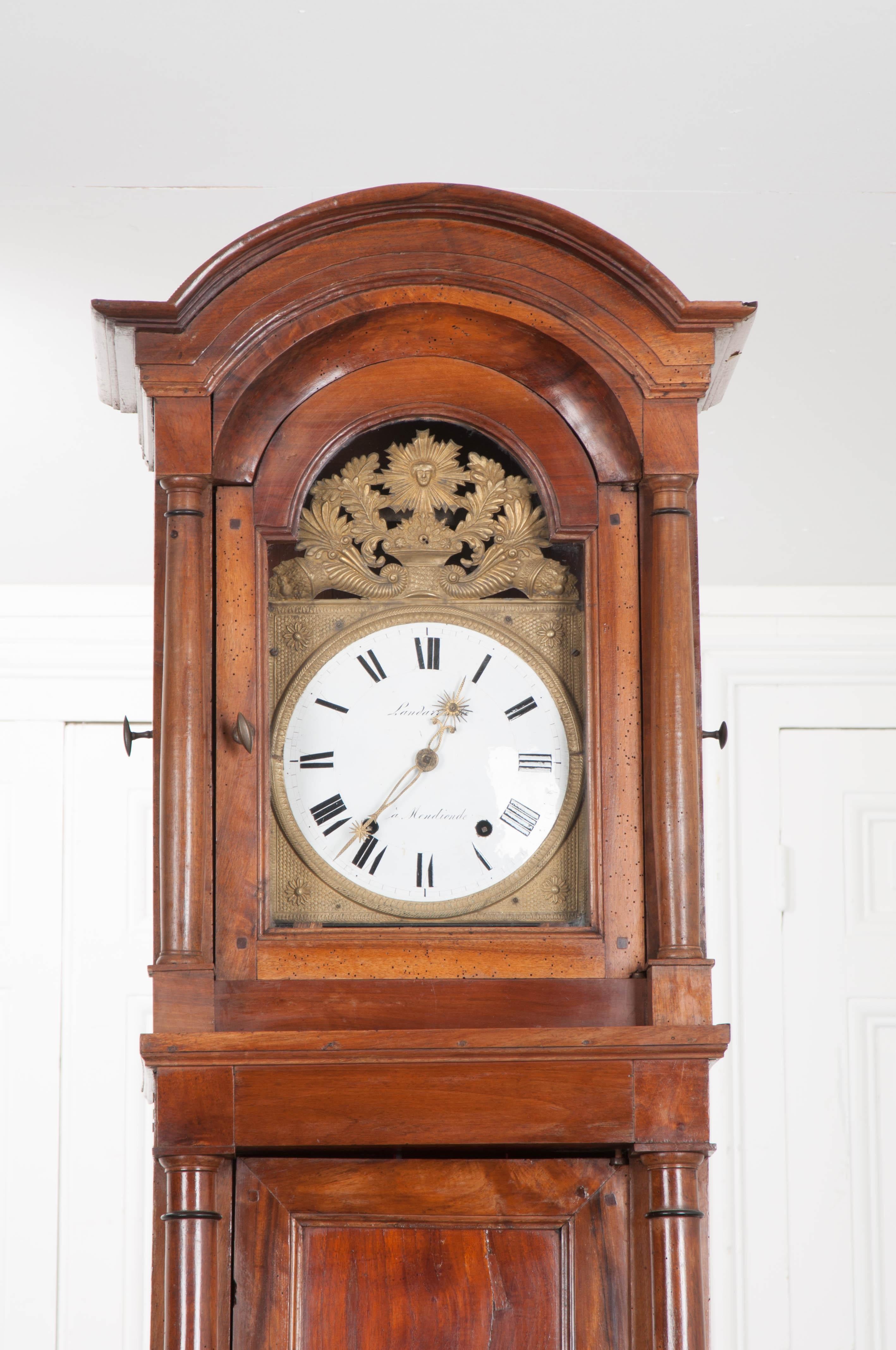 This outstanding Louis Philippe walnut tall case clock, circa 1840, was made by Landerretche à Mendionde, France and features a gorgeous wood grain and patina from years of proper French polishing. The enameled dial has been hand-painted with black