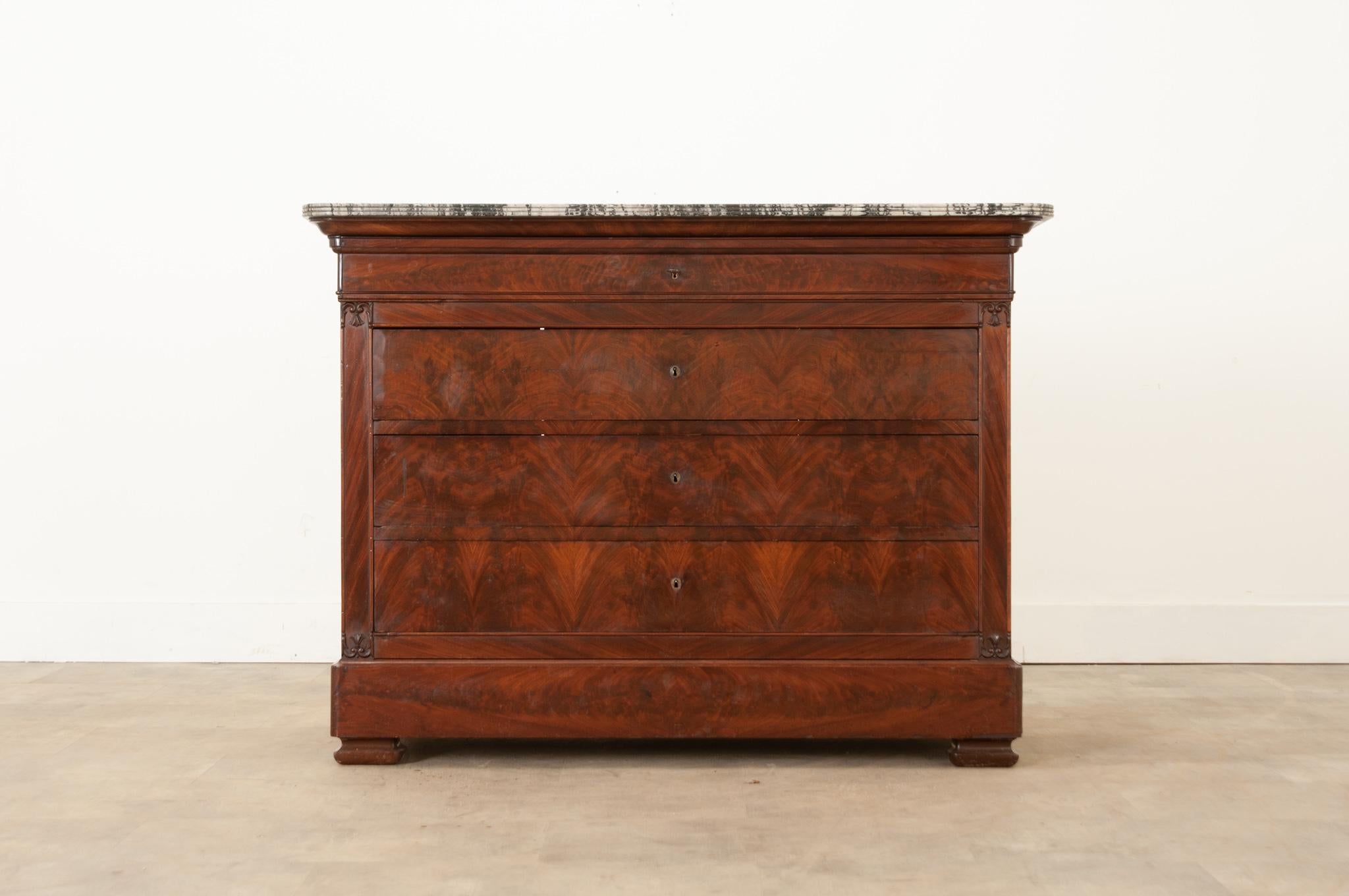 A fine 19th century Louis Phillippe style French mahogany commode, circa 1850. The original marble top in superb antique condition has rounded corners and is shaped to match the base. The marble showcases the wood grain perfectly. Five bookmatched