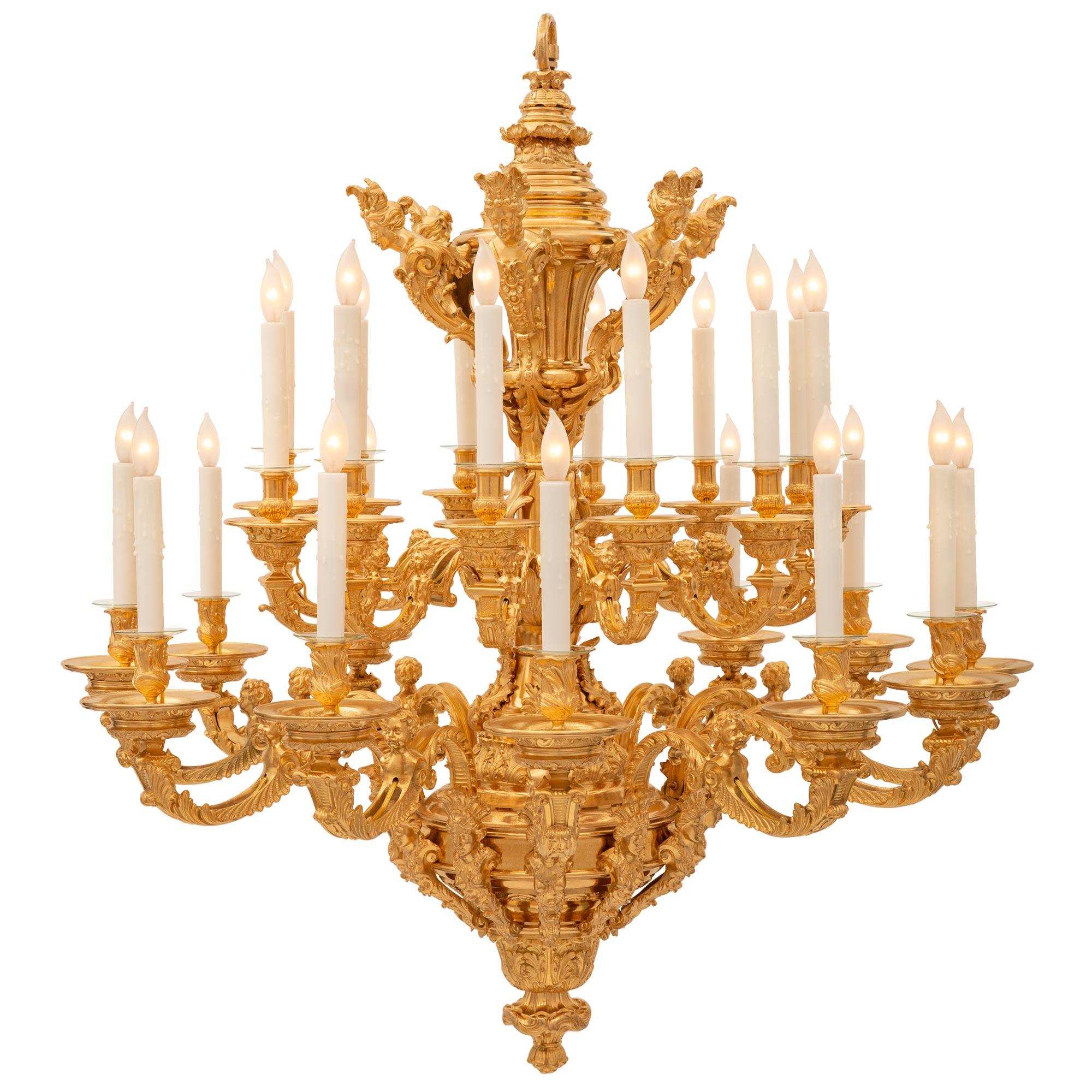 A spectacular and extremely impressive French 19th century Louis XIV st. Belle Époque period ormolu chandelier. The large scale twenty four arm chandelier is centered by a striking bottom foliate finial below large acanthus leaves and a most