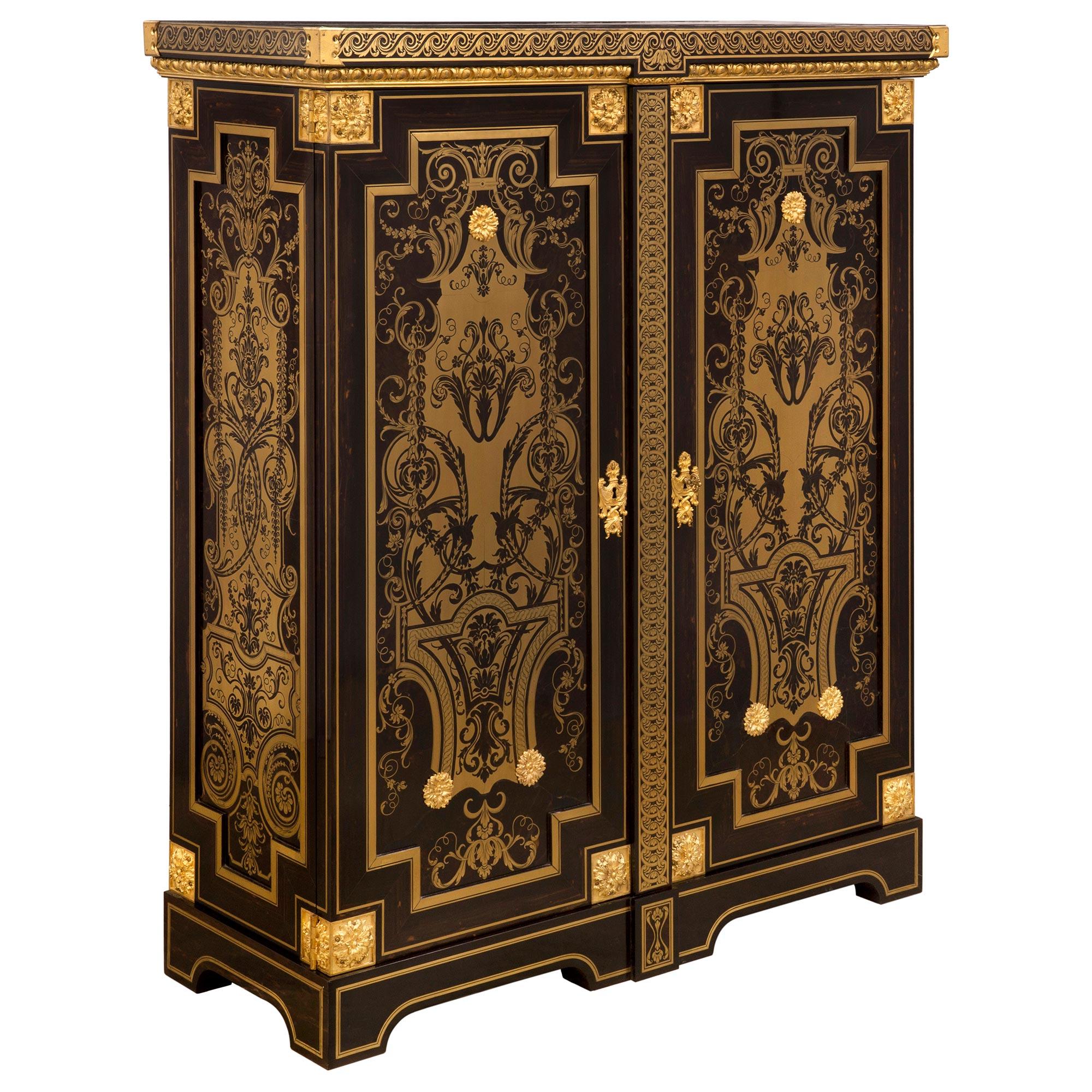 A spectacular French 19th century Louis XIV st. ebony, brass and ormolu cabinet, in the manner of A.C. Boulle. The exquisite cabinet is raised by elegant arched shaped supports with fine brass fillets and a central foliate reserve. The two central