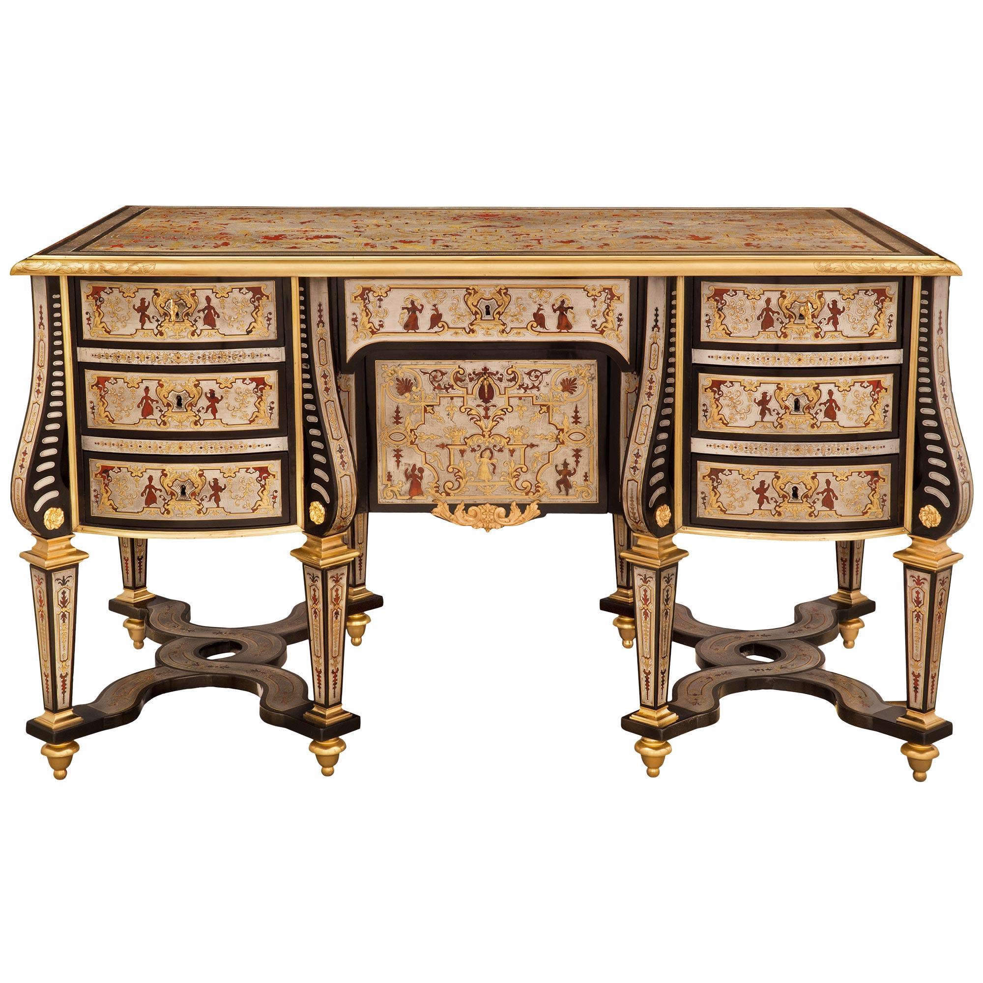 A stunning and rare French 19th century Louis XIV St. ebony, ormolu, pewter, and tortoiseshell Boulle Bureau Mazarin desk. The seven drawers, one door desk is raised by eight striking square tapered legs with topie shaped ormolu feet and beautiful