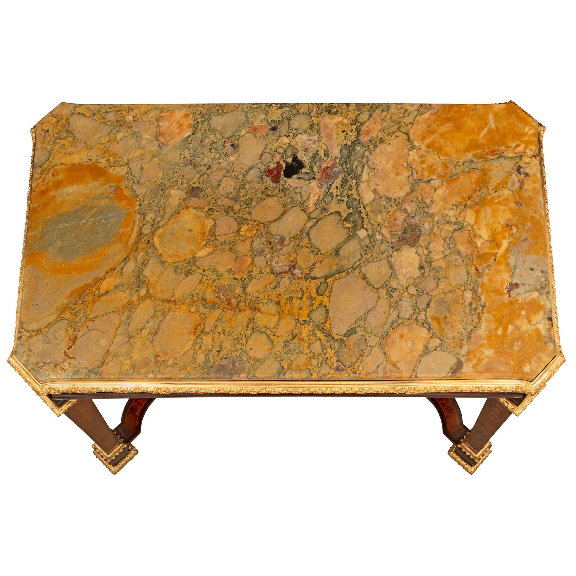 A stunning and extremely decorative French 19th century Louis XIV st. Kingwood, burl Walnut, ormolu, and Brèche marble side table. The table is raised by impressive square tapered legs with beautiful mottled feet, striking wrap around foliate ormolu