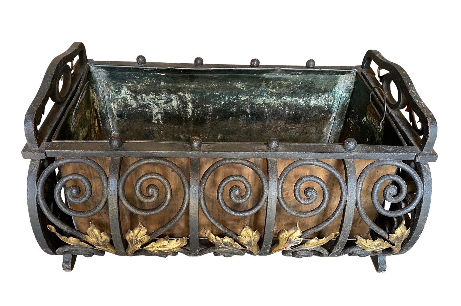 A lovely 19th century French Louis XIV style Jardiniere handsomely crafted from iron with its original copper liner. Perfect for any interior or garden.