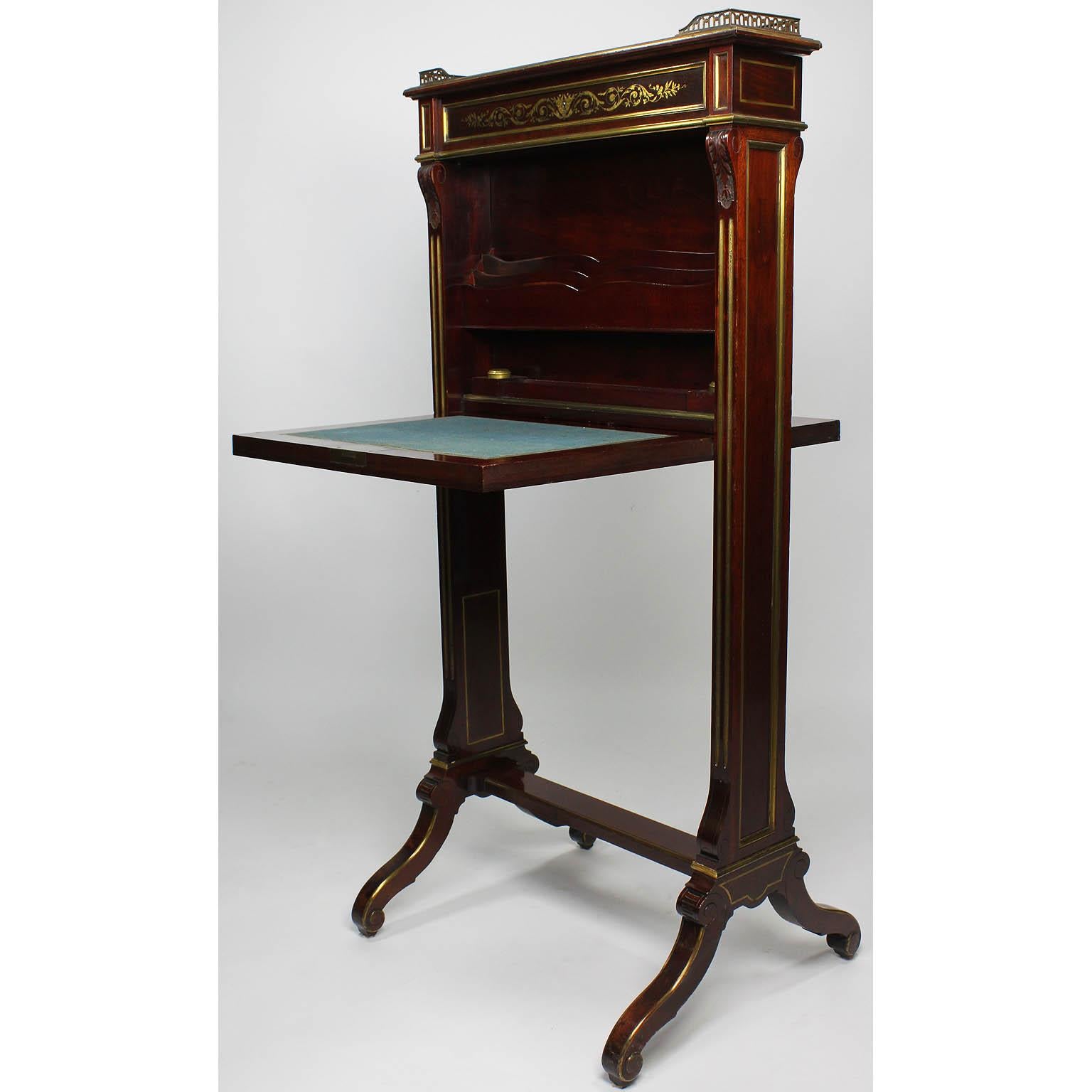 A fine and rare French 19th century Louis XIV style mahogany and brass inlaid drop-front freestanding secretary desk in the manner of André-Charles Boulle. The slender mahogany body centered with a finely chased gilt-brass inlaid floral and