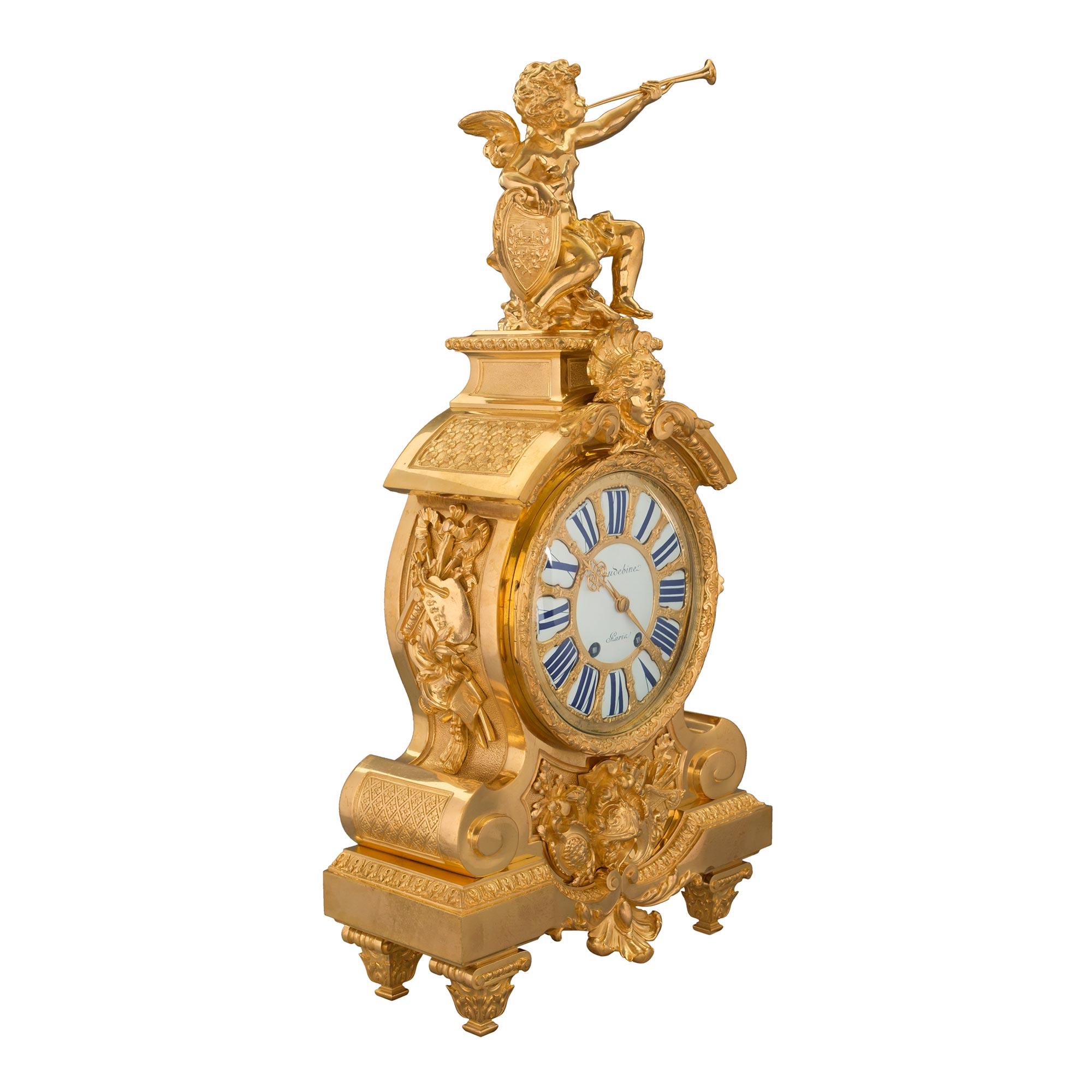 An extraordinary and high quality French 19th century Louis XIV st. ormolu three piece clock and candelabras garniture set. Each raised by square tapered fluted feet with fine acanthus leaf sabots. The clock displays a magnificent family crest