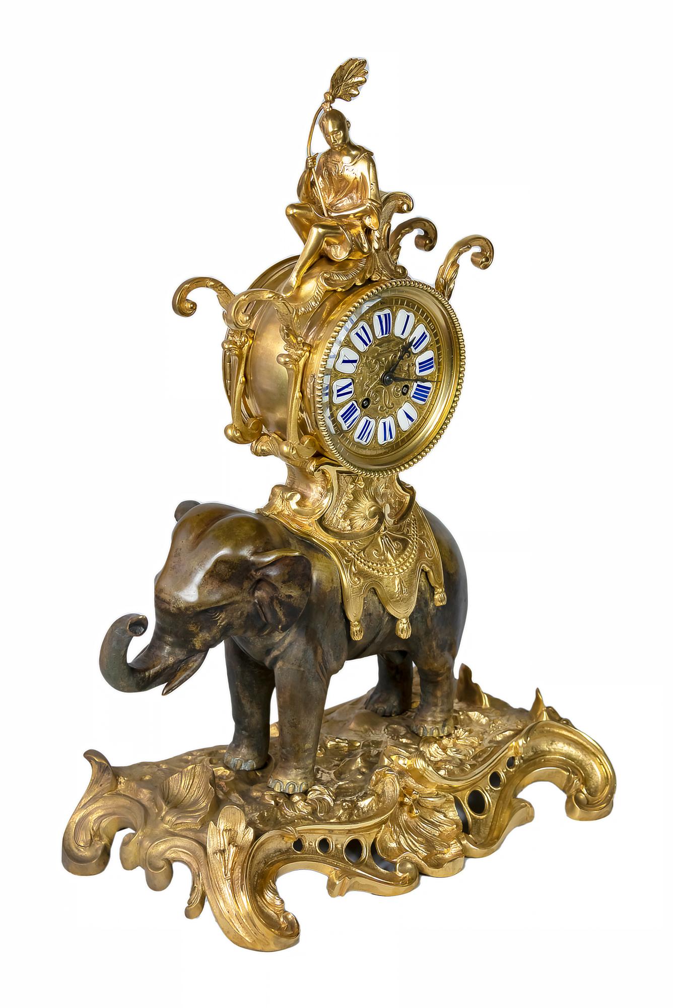 French 19th century Louis XV stile gilded bronze mantel clock created in the manner of Chinoiserie.
The base is in gilt bronze with the patinated bronze sculpture of an Asian elephant carrying saddle with sitting Chinese man in it. 
The dial is