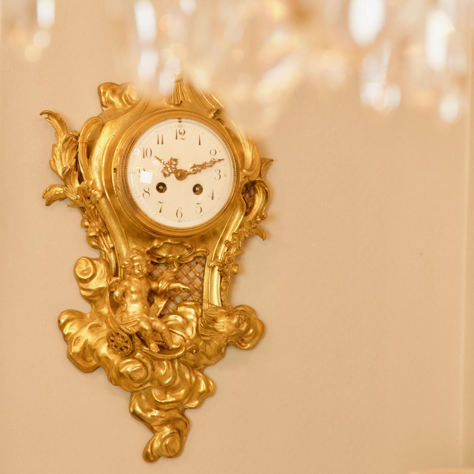 French 19th Century Louis XV Gilt Bronze Amor Cartel Clock, Manner of Philippe Caffieri

The white enamel dial with Arabic numerals, contained within a cartouche-shaped case surmounted by a star, rocks and C-scrolls, flanked by acanthus leaves, the