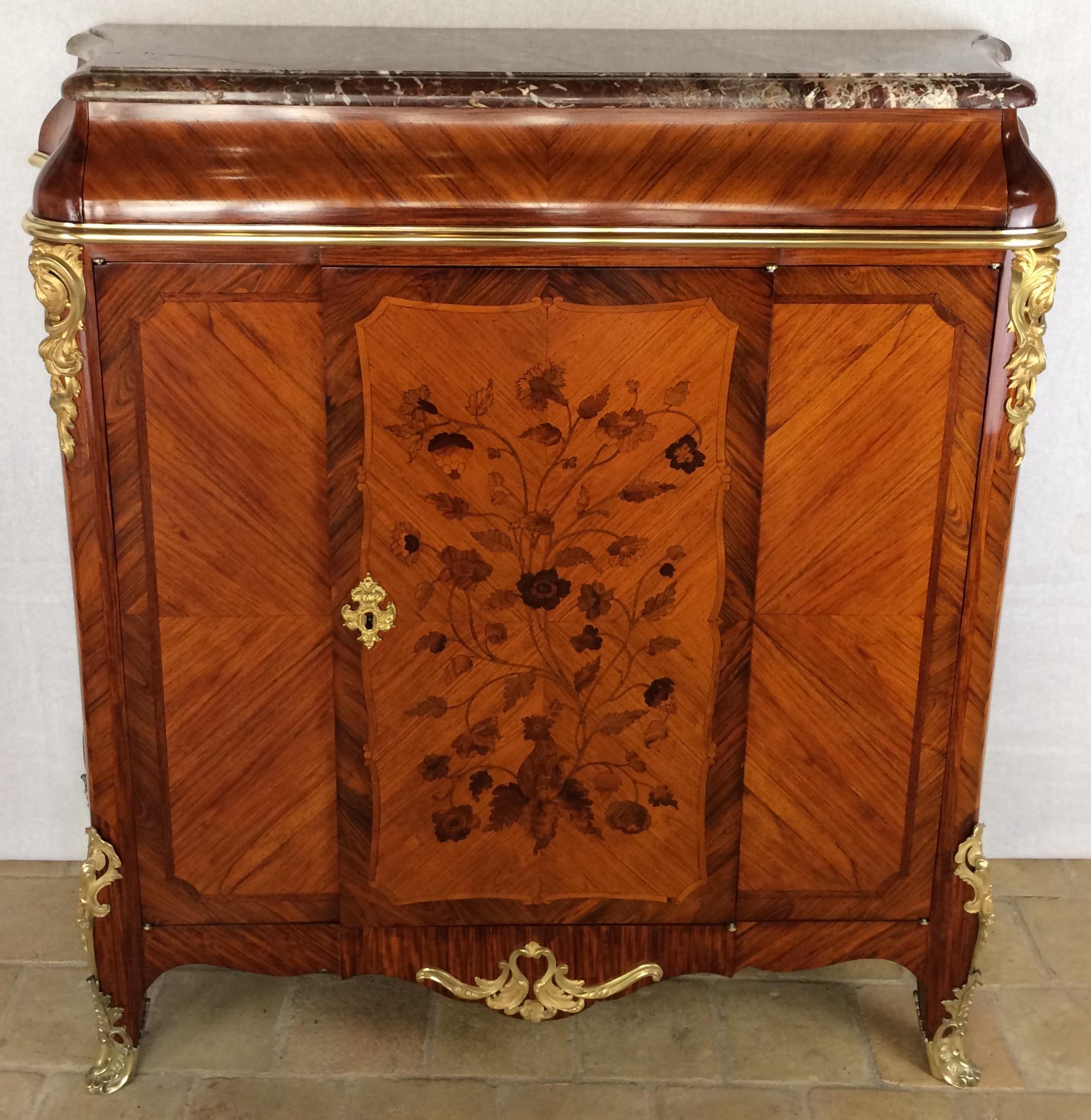 A very fine Louis XV Style cabinet in the manner of Paul Sormani.

This exquisite and very well proportioned cabinet is made of bois violette or kingwood, with well executed floral inlays. Extensive gilt bronze mounts of exceptional quality. The