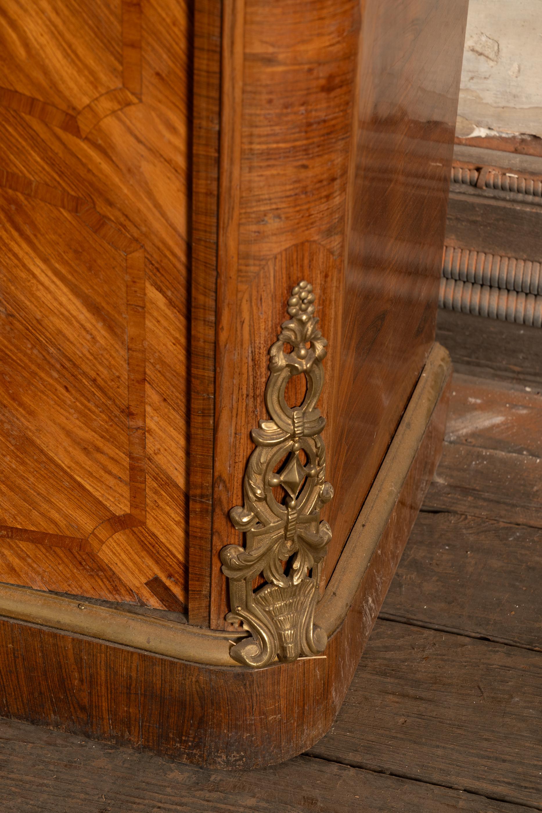 Beautiful French 19th Century Louis XV ten door cabinet showcases three detailed Coromandel panels. The piece features gorgeous bronze d'ore mounts most notable seen on the diagonal corners, as well as wrapped at top, middle, and bottom. The hand